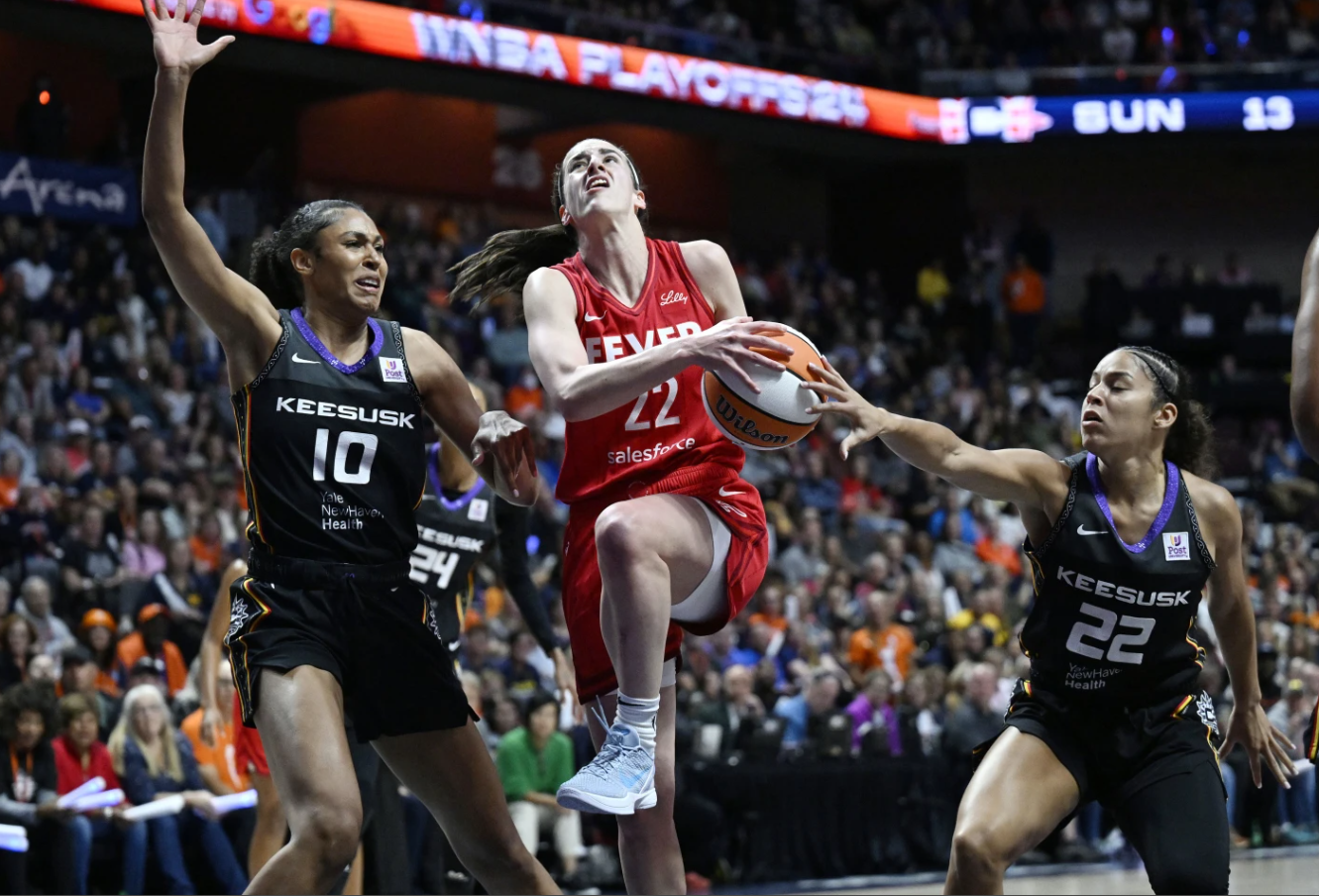 Indiana Fever guard Caitlin Clark (22) goes to the basket as Connecticut Sun forward Olivia Nelson-Ododa (10) and guard Veronica Burton (22) defend during the first half in game 2 of a first-round WNBA playoff series, Wednesday, Sept. 25, 2024 in Uncasville, Conn.
