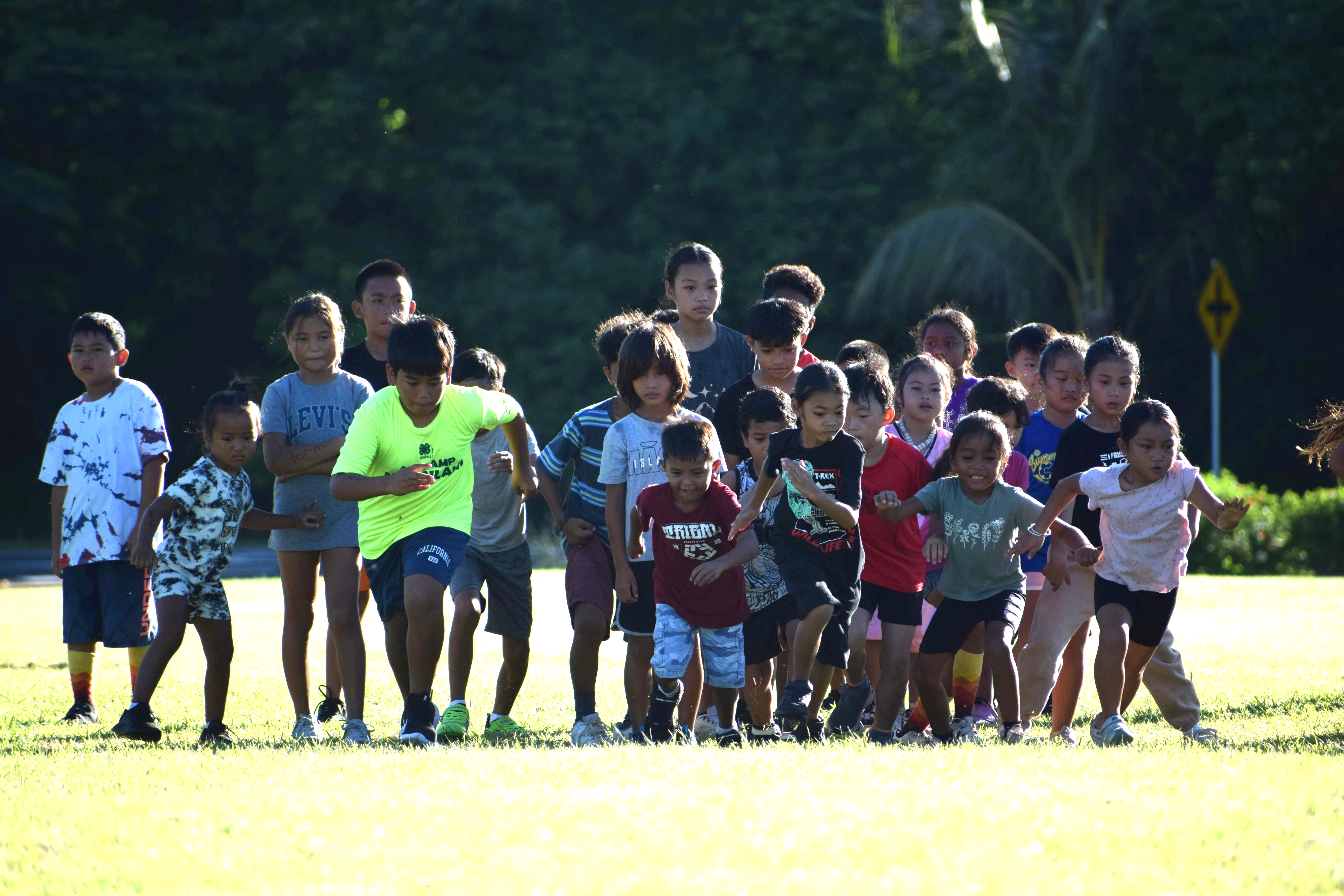 Elementary school students participate in the Public School System Cross Country event at airport field on Saturday.