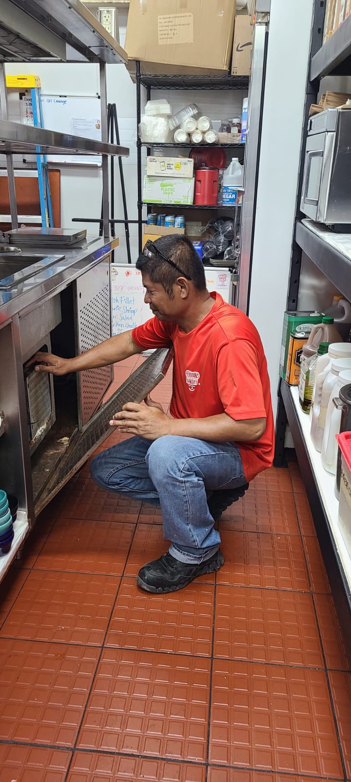 Robert Sierra is shown fixing and tinkering with one of the machines at Herman's Modern Bakery.