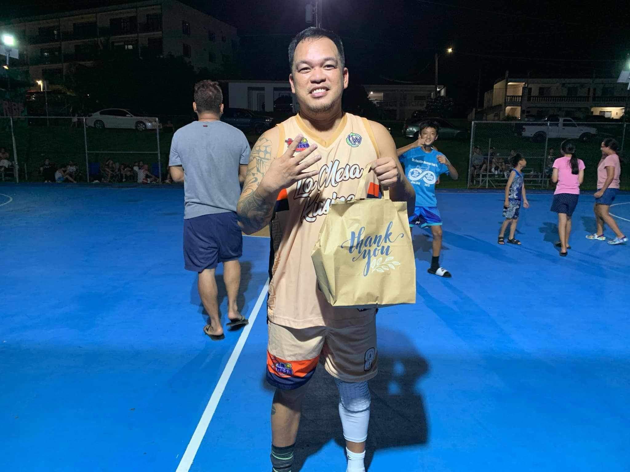 HBR’s Jun Hernandez holds his prize after being named player of the game in the match against Tsingtao JTM in the Win Pacific Corporation Invitational Basketball League at the Gualo Rai Basketball Court on Saturday.