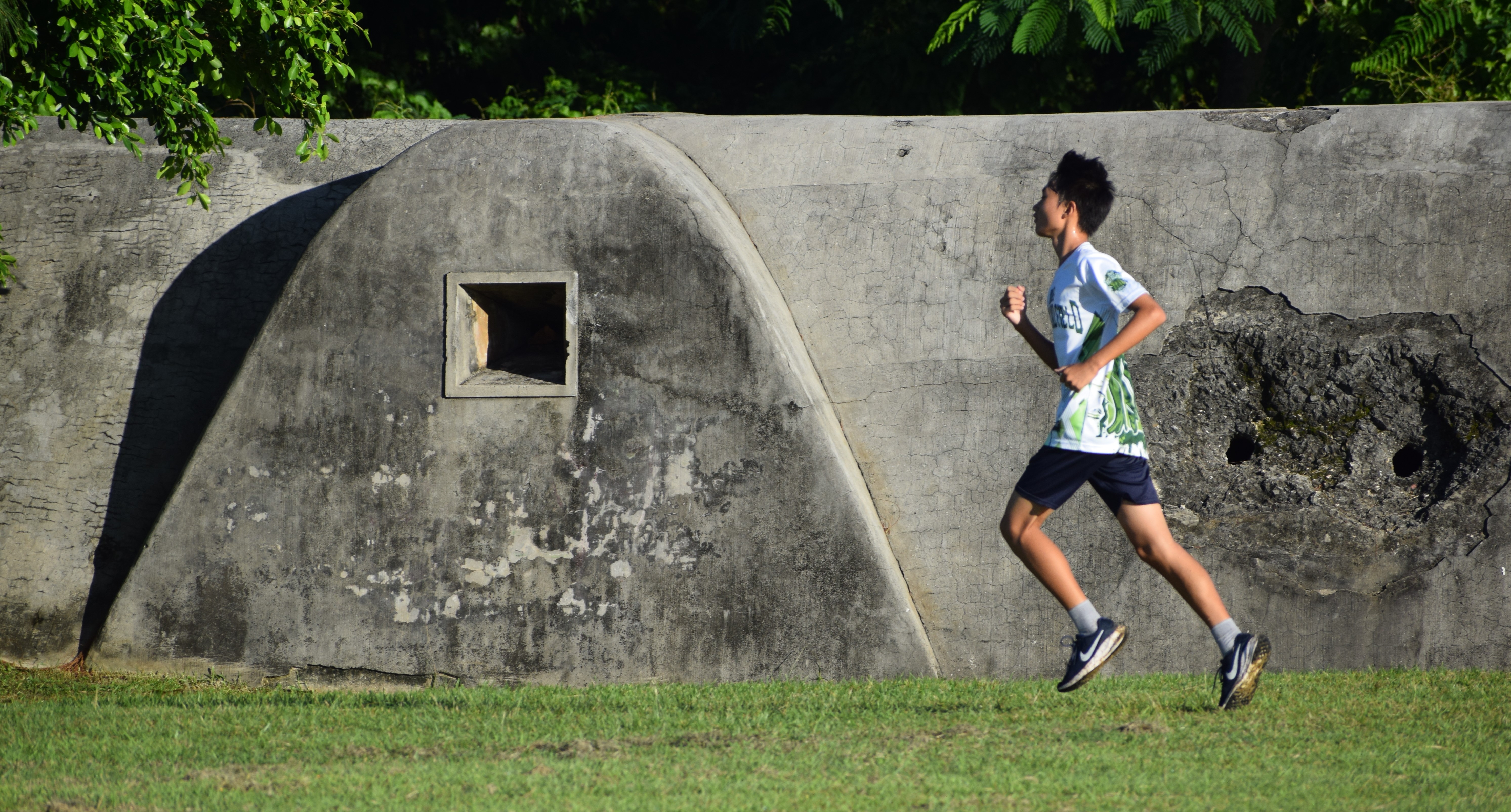 Dandan Middle School's Luxi Lu passes by an old Japanese bunker.