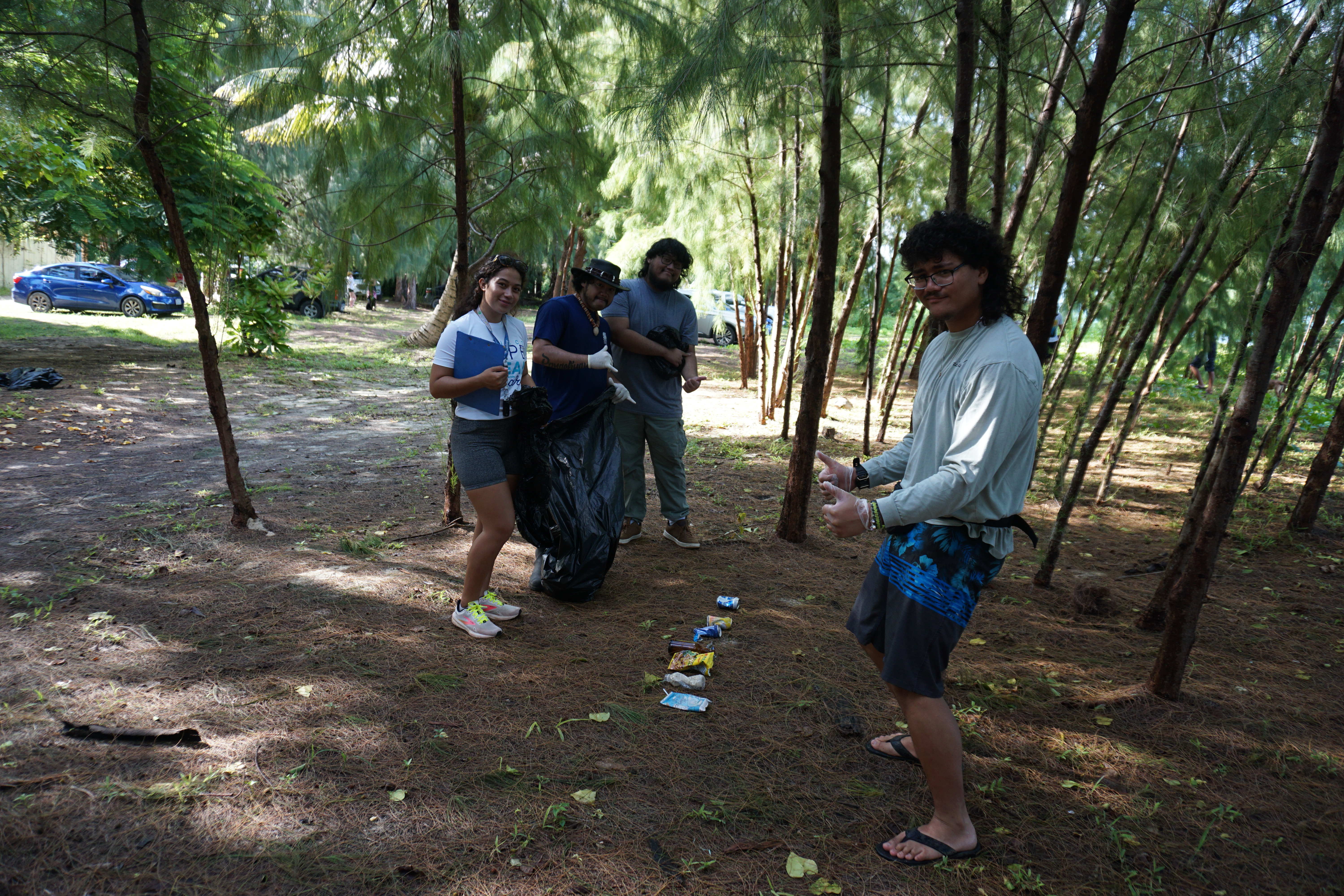 Island residents at Makaka Beach take note of what litter they found there on September 21. ​