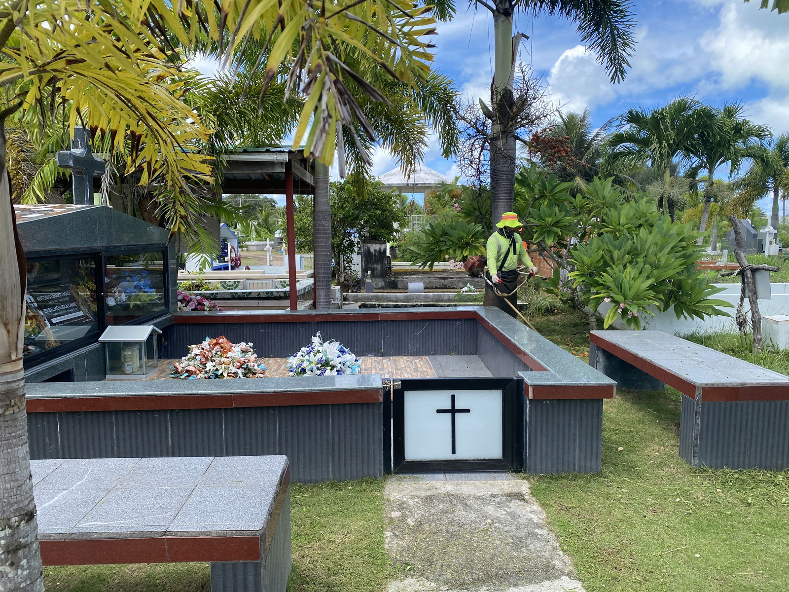 Many graves are well maintained at the Tanapag cemetery. A municipal staff member is seen trimming grass on Saturday, Sept. 7.
