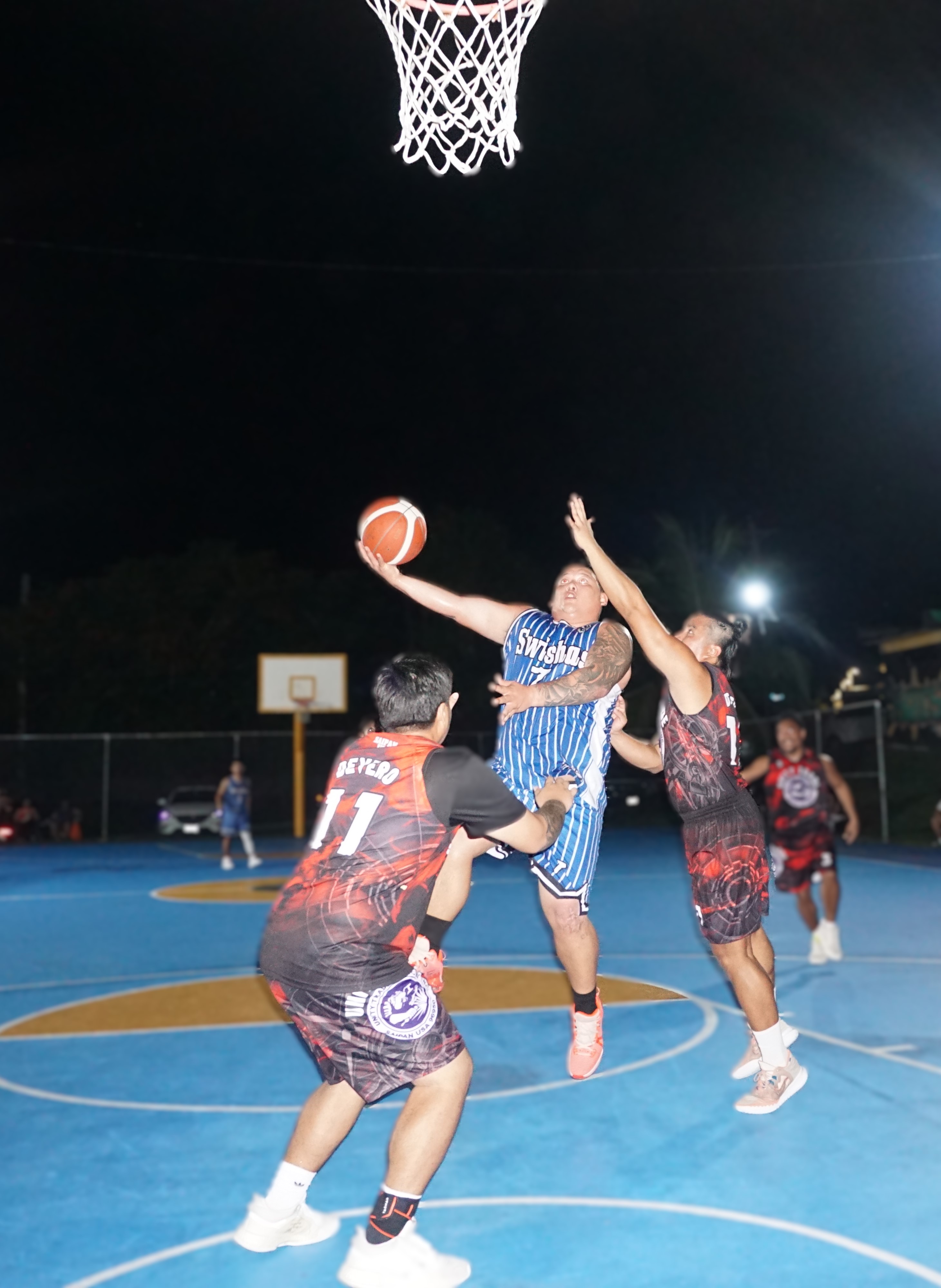 Swisha's Matt Duenas gets fouled as he extends for the finish during a game against Unity Trade in the semi-open division of the Win Pacific Corporation Invitational Basketball League 2024 at the Gualo Rai basketball court. 