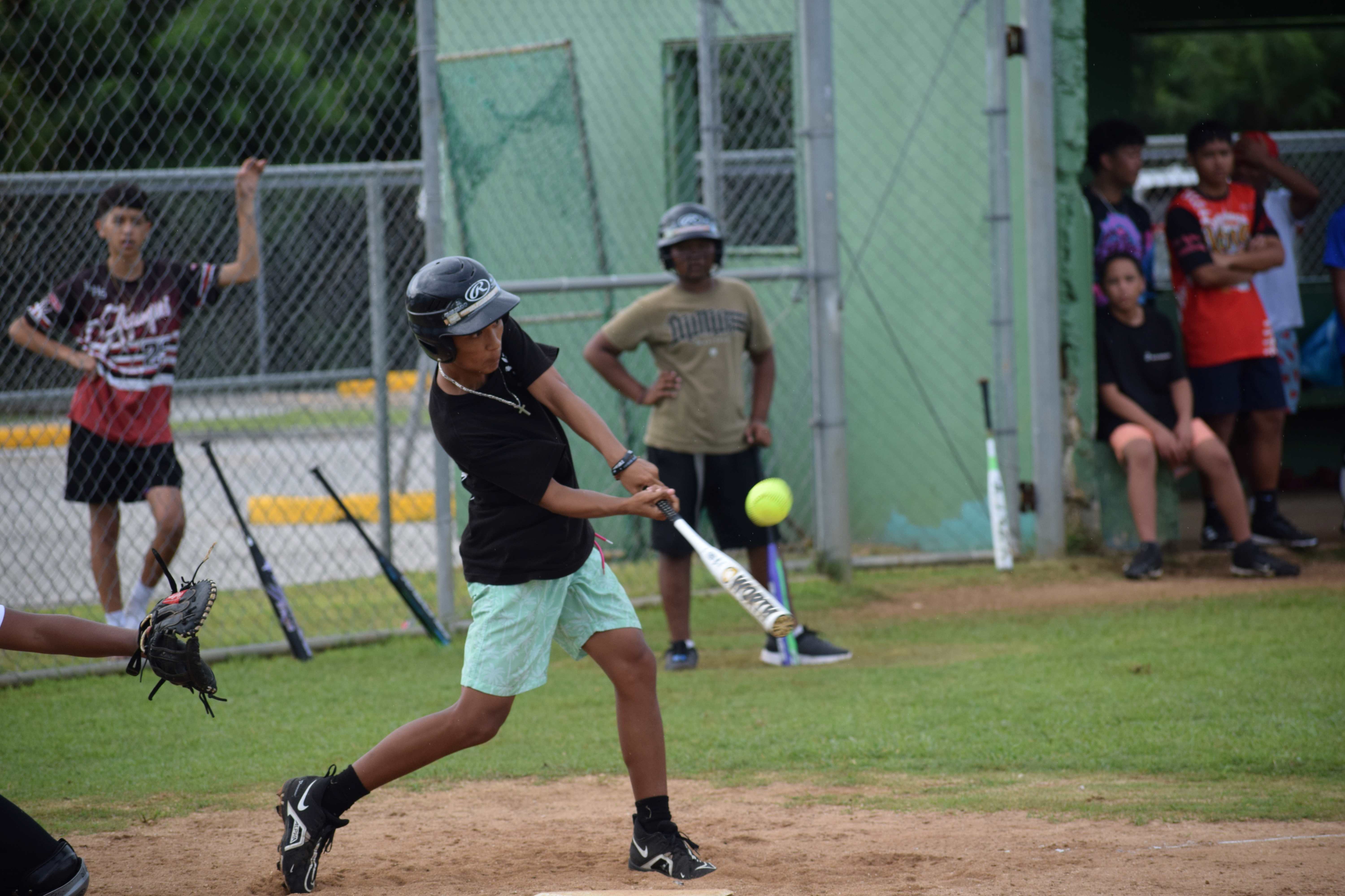 Kagman High School’s Abraham Falig hits the ball.