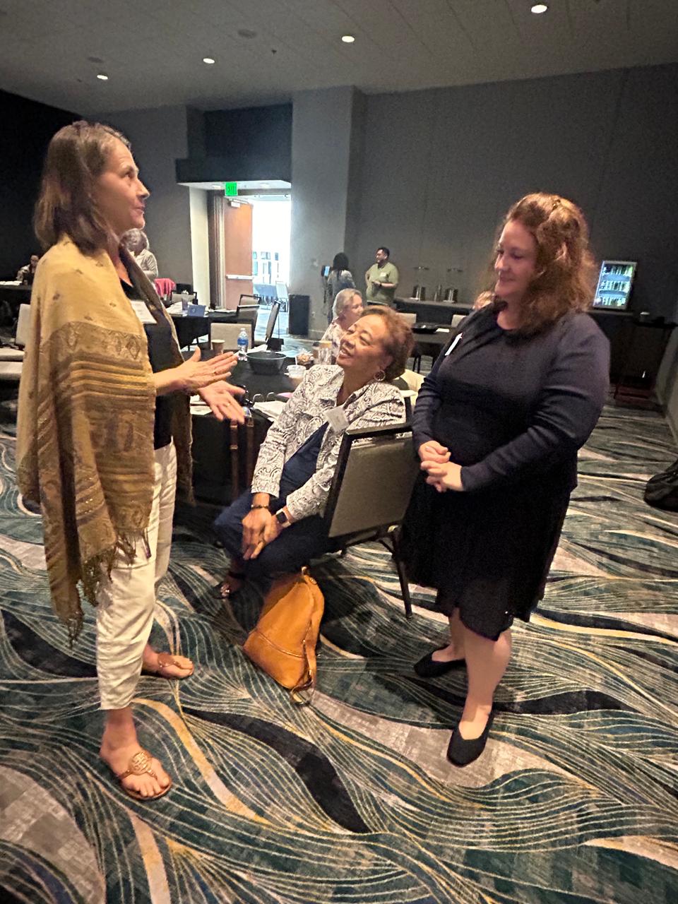 Laurie Peterka, left, development & communications director for MANGO, shares ideas with other regional leaders.