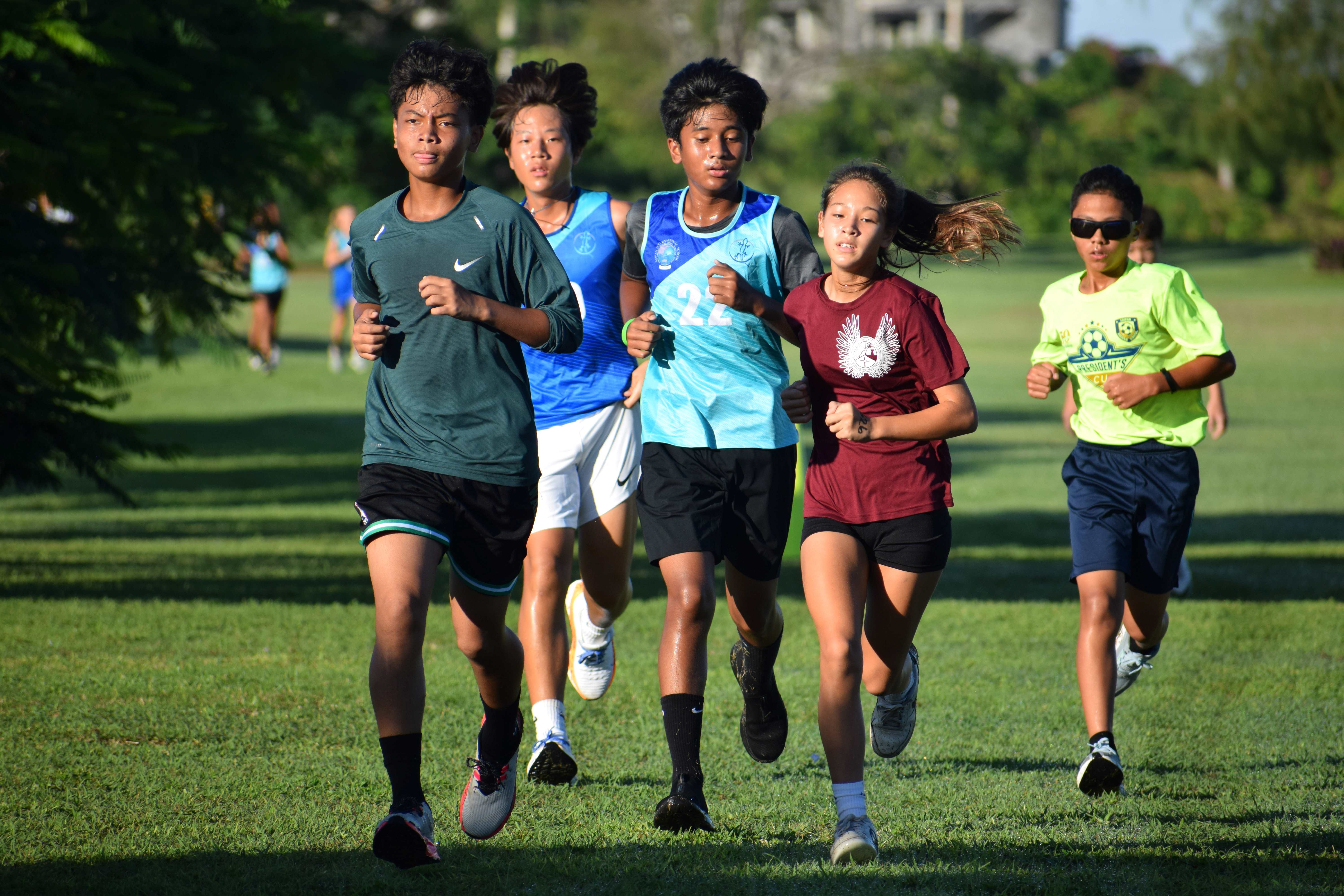 Middle school students race to complete the first lap in the two-mile run event.