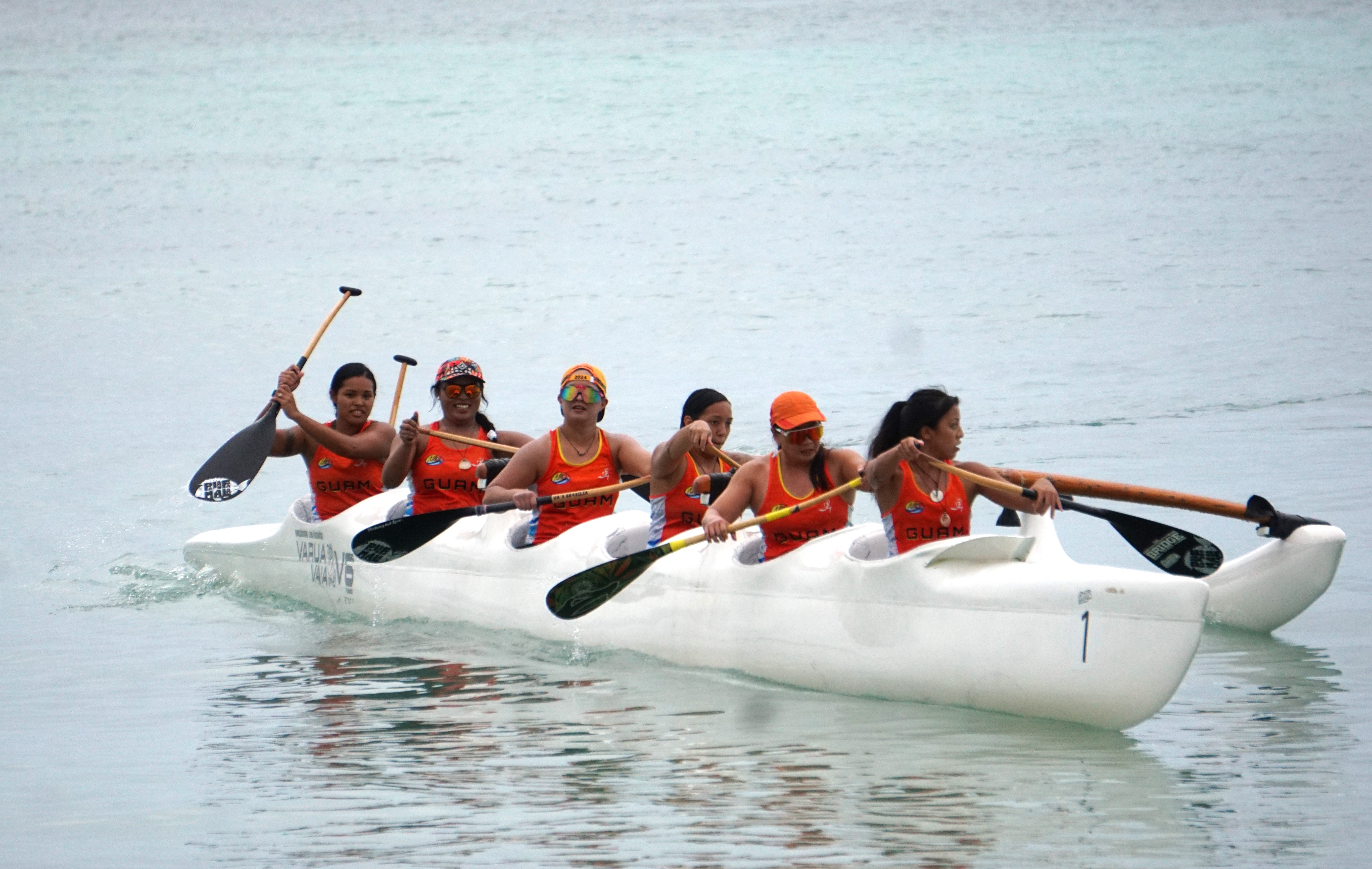 Napu's women paddlers take a breather after placing first in the V6 500m event of the 24th Micronesian Cup at Crowne Plaza Resort Saipan Beach on Saturday. 