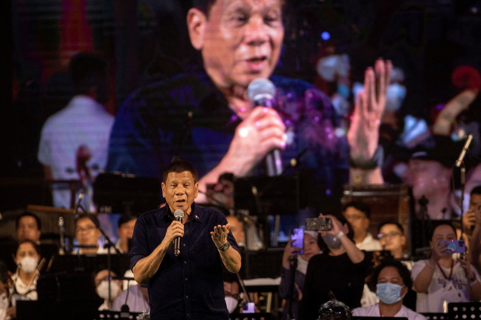 Philippine President Rodrigo Duterte sings to his supporters during a thanksgiving concert held before he ended his six-year term at the Quirino Grandstand in Manila, June 26, 2022.
