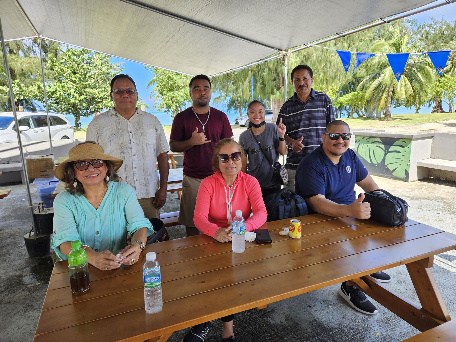 Precinct1 Rep. Diego Camacho, right seated, with former Yap Lt. Gov. James Yangetmai, husband of Precinct 3 Rep. Denita Yangetmai (not in photo), and Democratic Party supporters pose for a photo on Tuesday morning.