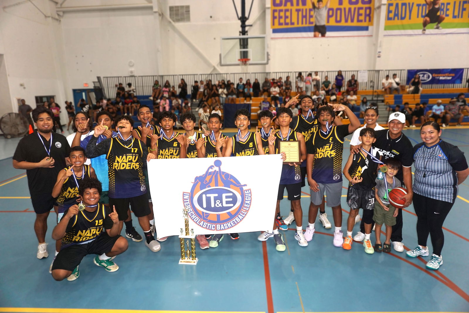 The Francisco M. Sablan Middle School team members pose with the boys middle school division championship trophy of the PSS-NMIBF IT&E Interscholastic Basketball League SY24-25 at the Marianas High School gym on Saturday.