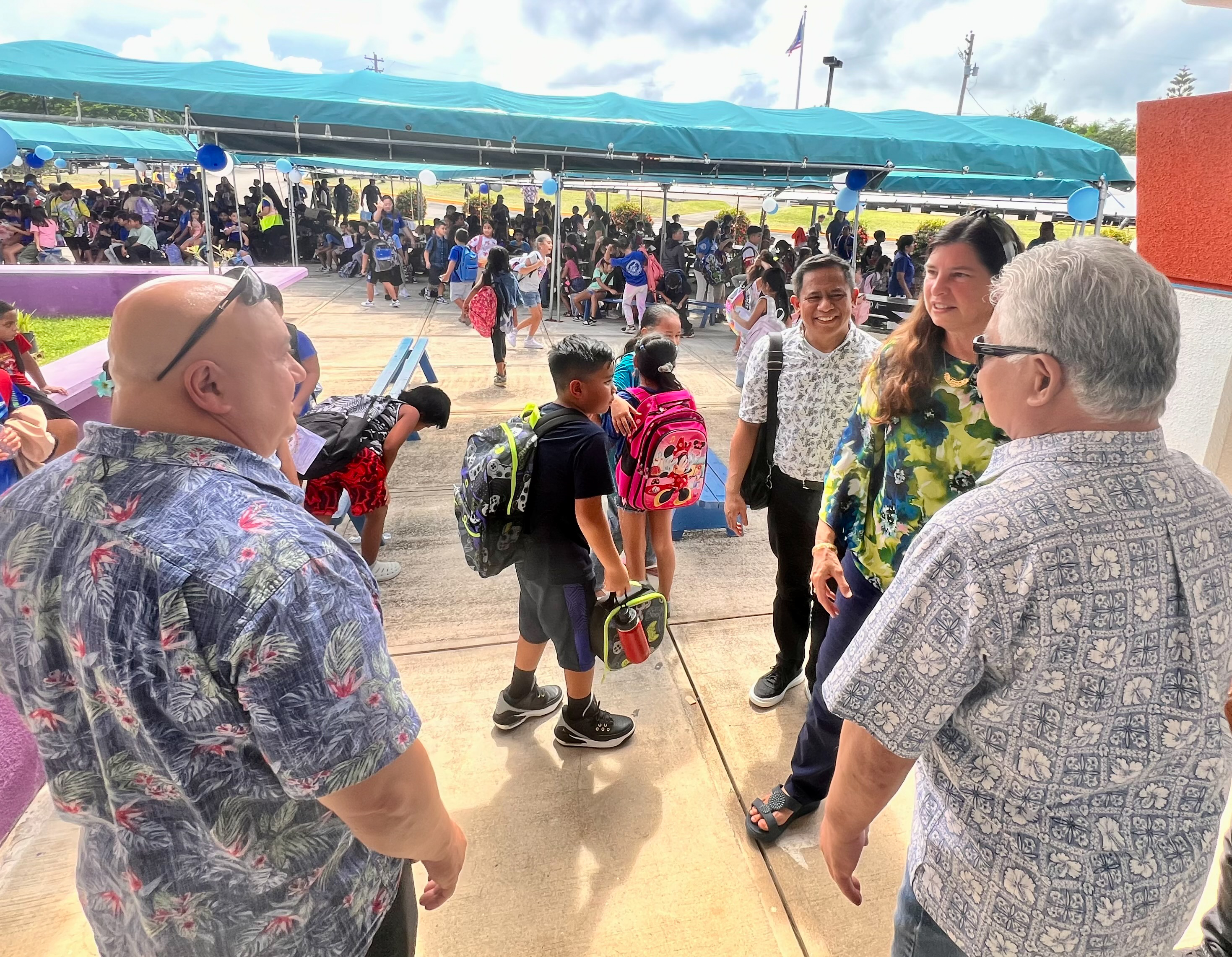 Gov Arnold I. Palacios and Commissioner of Education Dr. Lawrence F. Camacho converse with G4S Security (Guam) Inc. General Manager Teresa Sakasaki, right, after the ribbon-cutting ceremony.