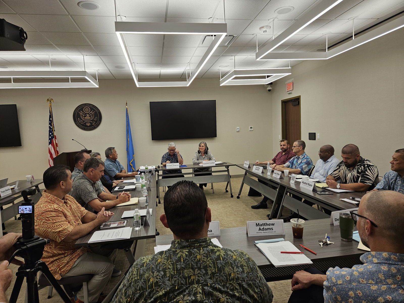 Gov. Arnold I. Palacios and Interior Assistant Secretary for Insular and International Affairs Carmen G. Cantor with the other members of the CNMI and U.S. 902 panels meet in a room at the federal courthouse in Gualo Rai on Thursday.