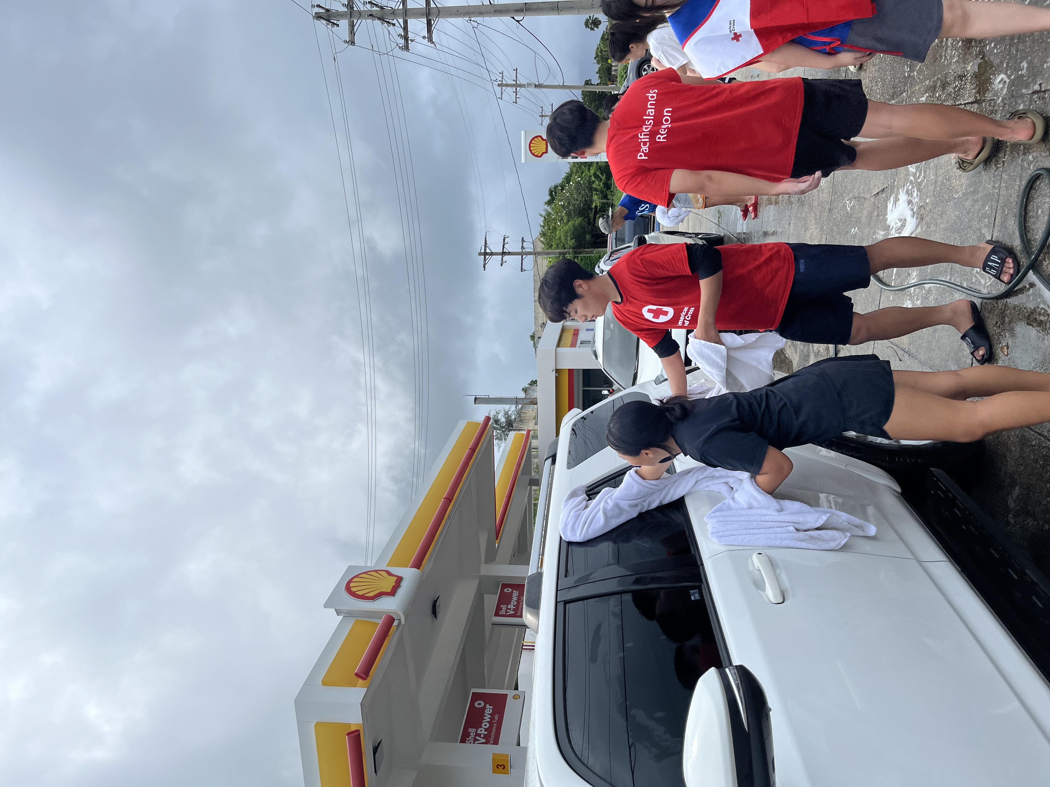 SIS and MCS students clean cars to raise funds for the American Red Cross.