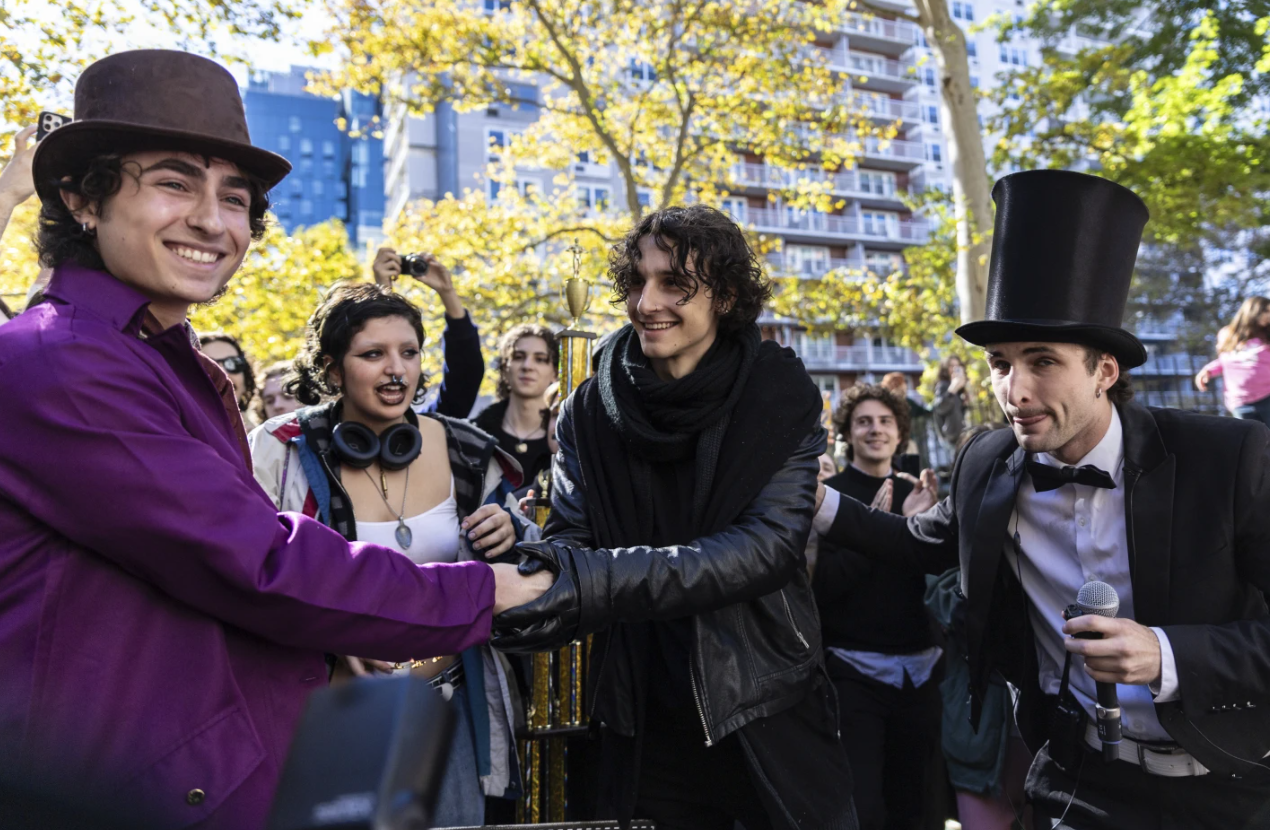 Finalists Miles Mitchell, left and Zander Dueve, center, shake hands at the Timothee Chalamet lookalike contest near Washington Square Park in New York on Sunday, Oct. 27, 2024.