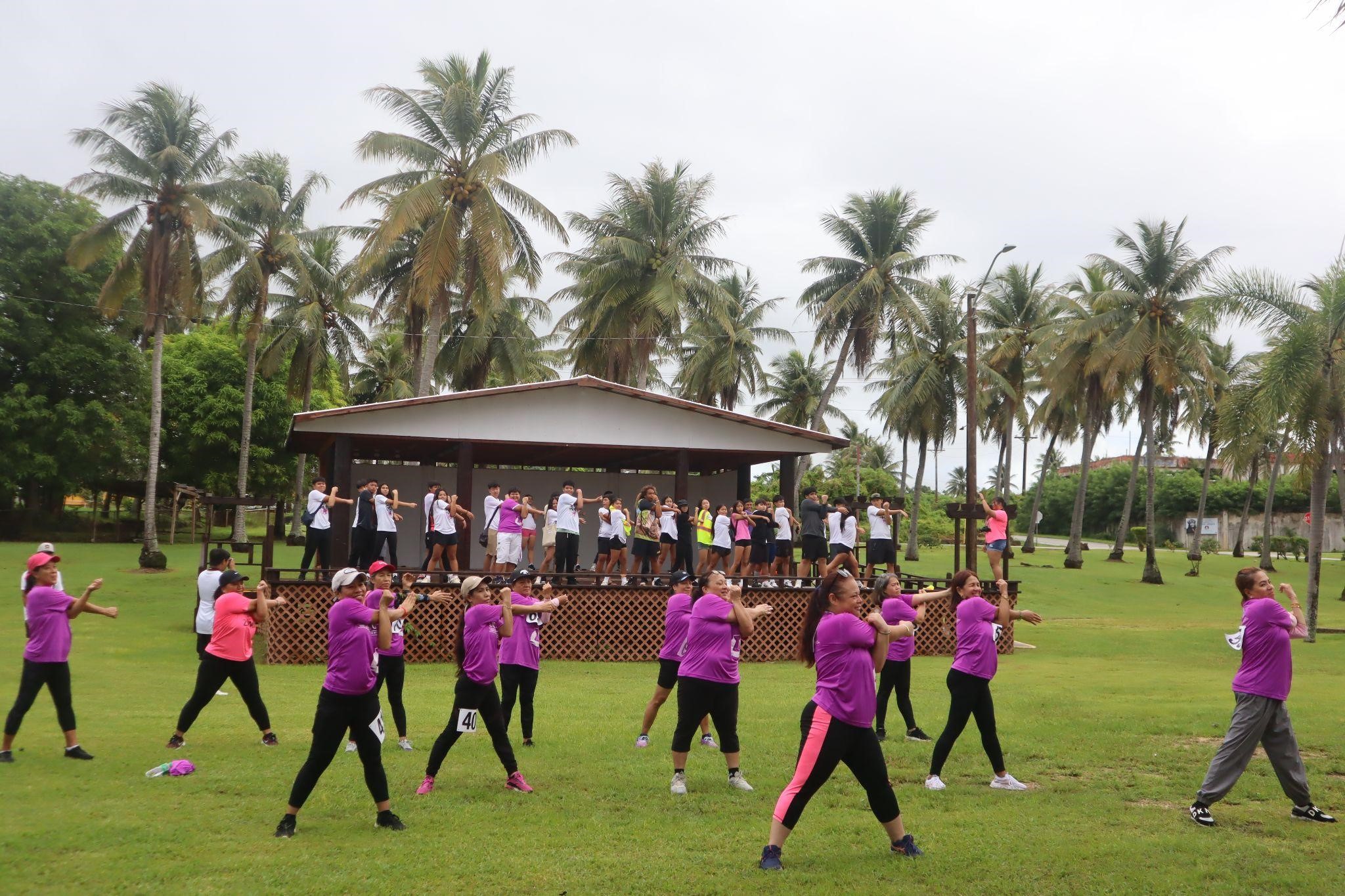 Stallion Battalion cadets participate in post stretching with a Tinian Zumba group.