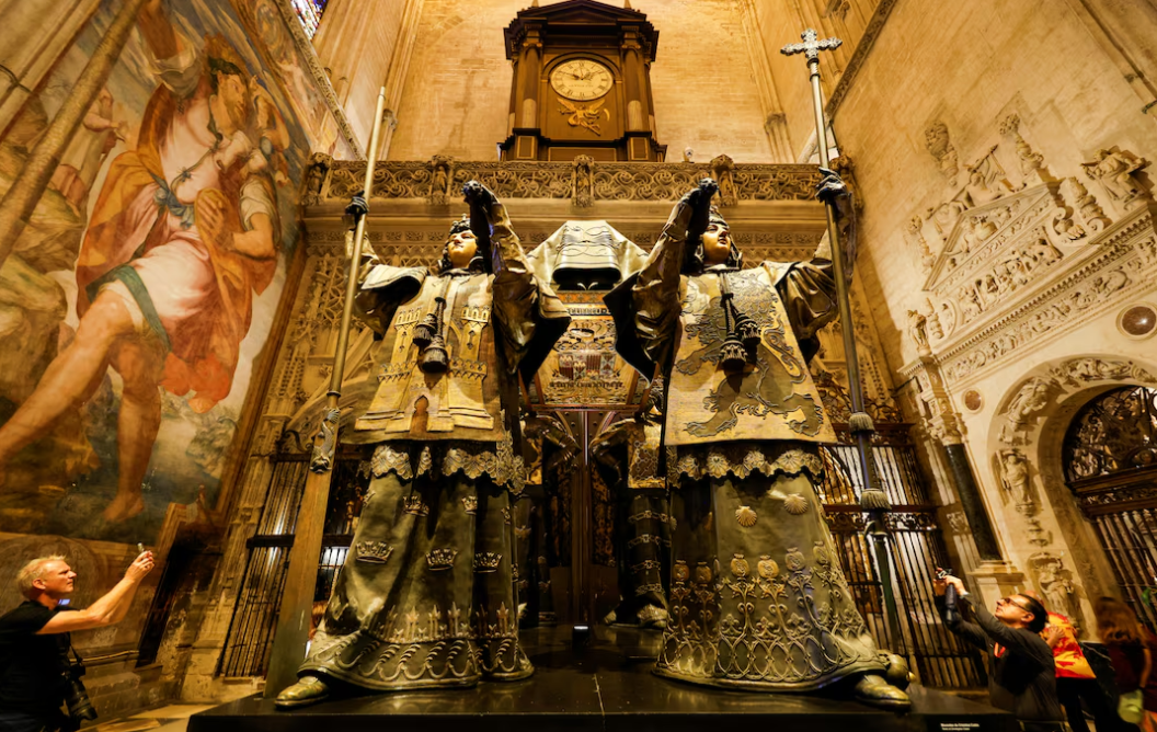 People visit the mausoleum of Christopher Columbus in the cathedral of Seville, Spain, Oct. 11, 2024.