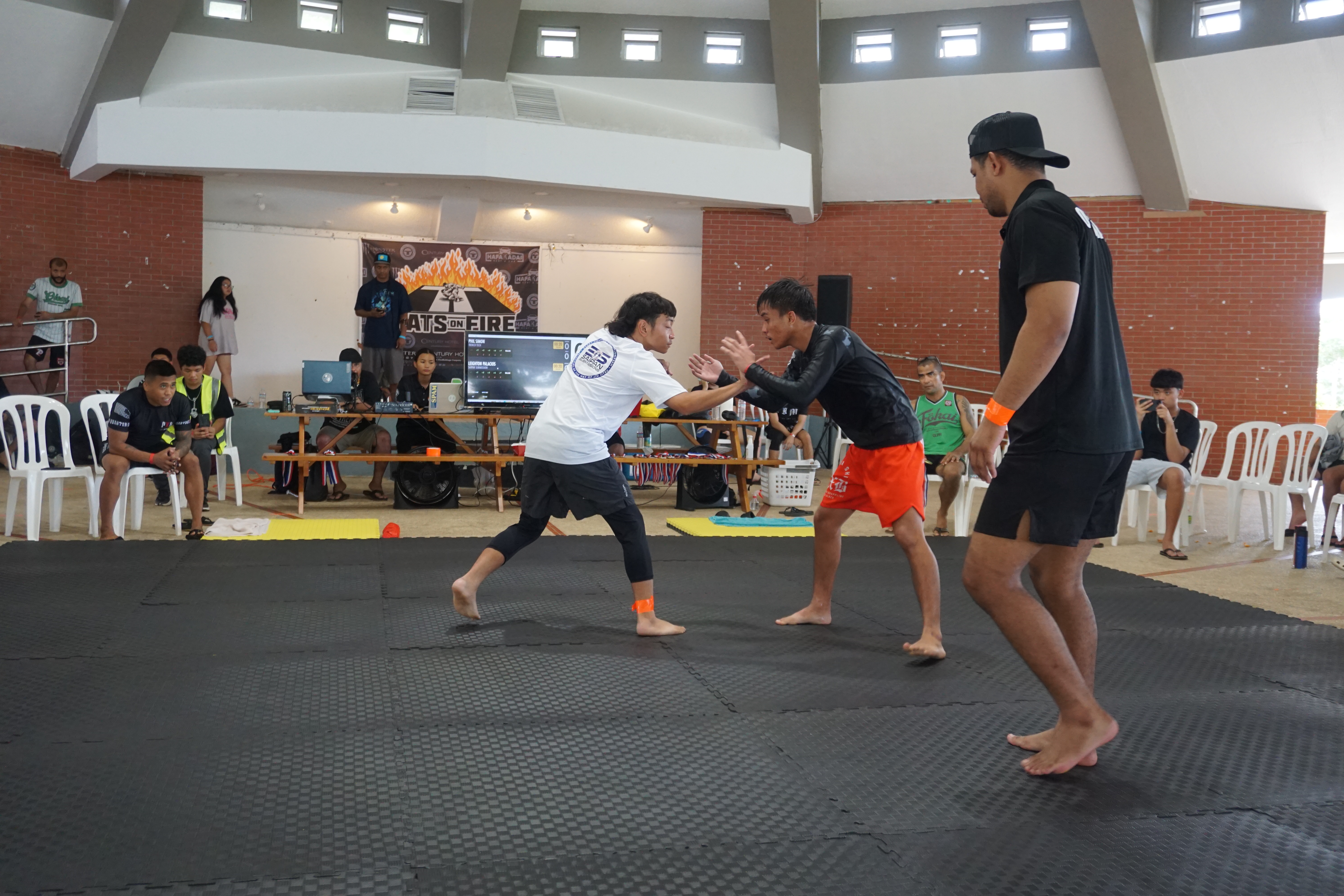 Leighton Palacios, in white, fights to secure a gold medal in the atomweight division.