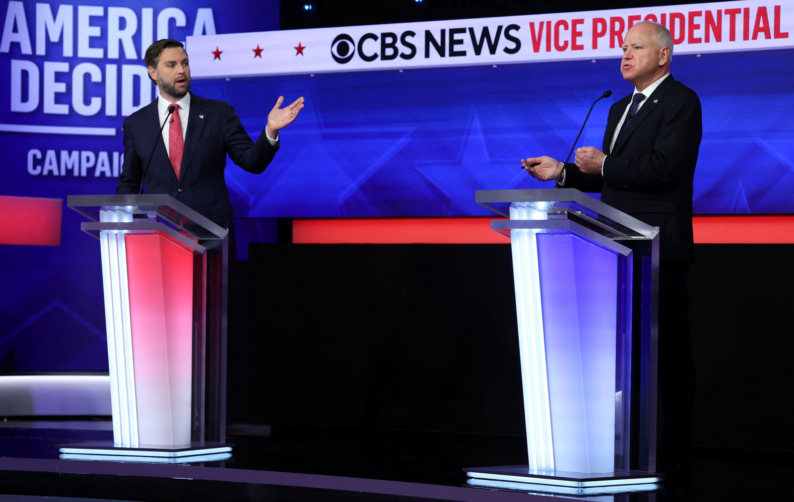 Republican vice presidential nominee JD Vance and his Democratic opponent Tim Walz gesture as they speak during a debate hosted by CBS in New York, Oct. 1, 2024.