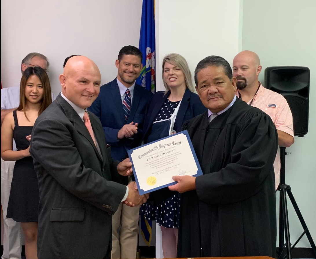 Chief Justice Alexandro C. Castro, right, congratulates Joe William McDoulett after swearing him in as a new CNMI attorney in this Oct. 2019 file photo.