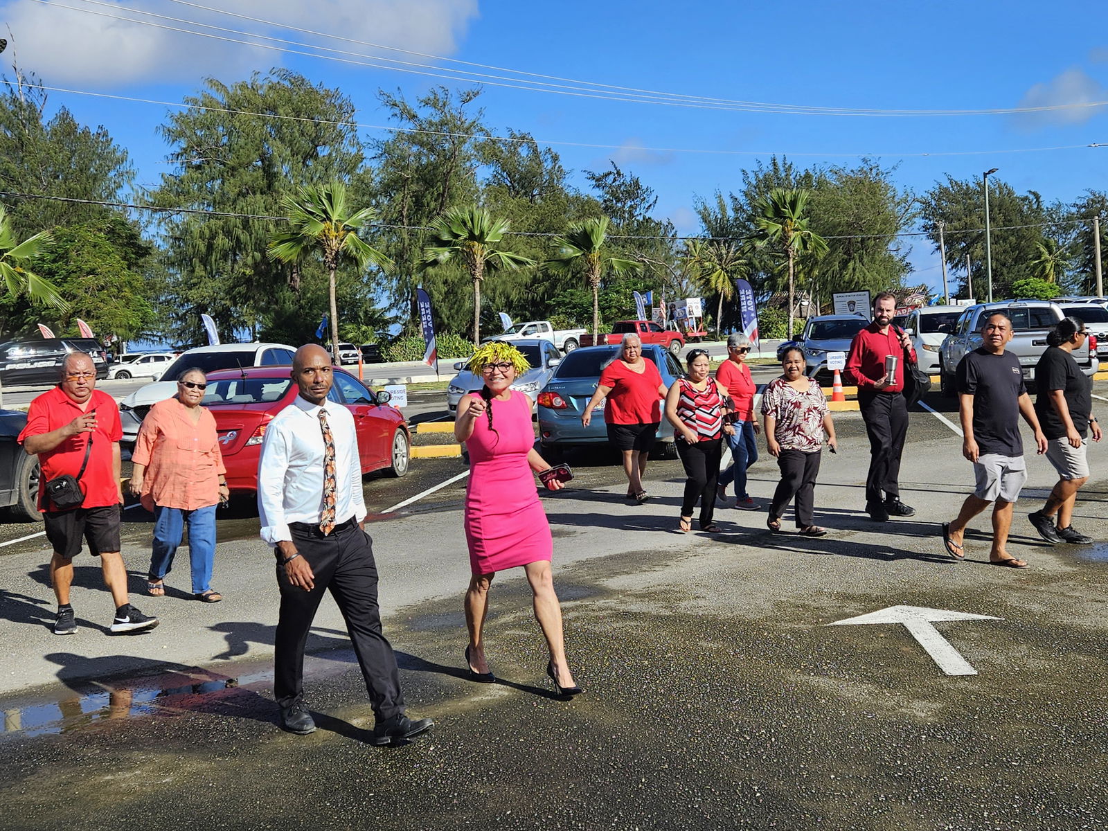 U.S. delegate candidate Kimberlyn King-Hinds, with husband Chester Hinds and other supporters, arrives at the multi-purpose center in Susupe to cast her vote on Tuesday morning.