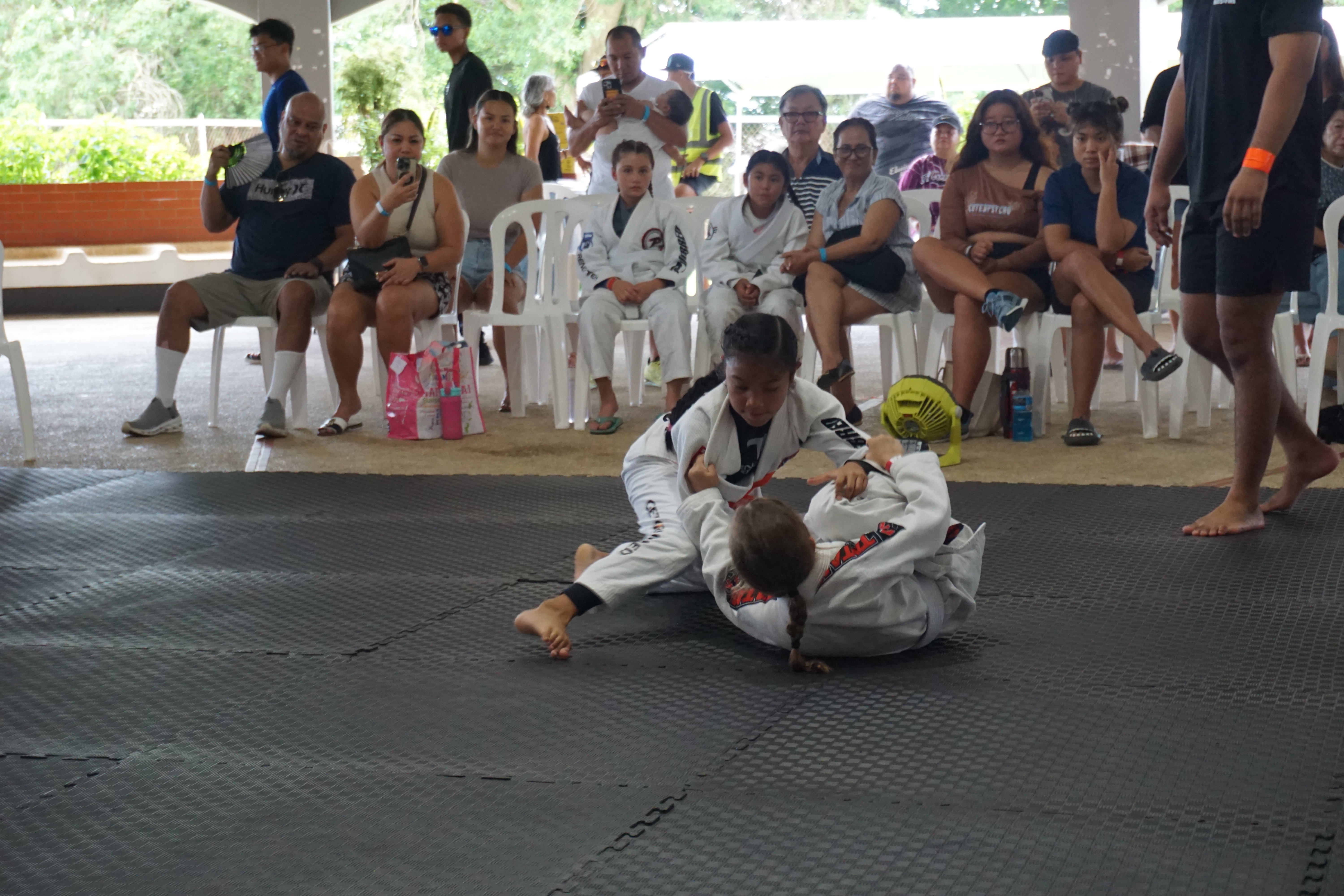 Kaiya Pangelinan locks in the armbar to secure the gold medal. 