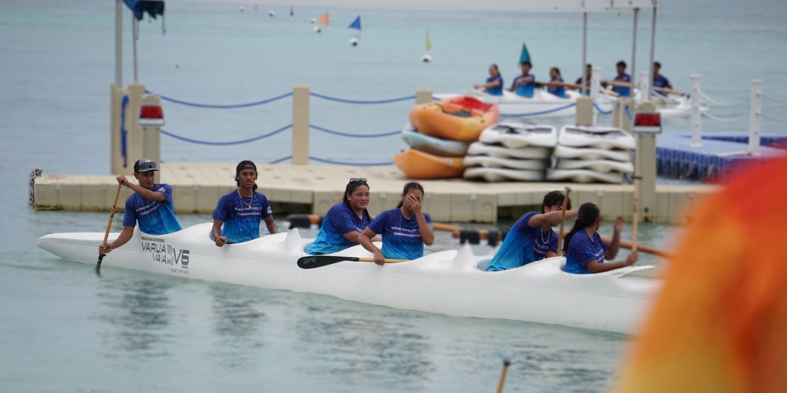 Saipan Paddling Club team captain Tyler Andrew, left, steers his team to shore after placing first in the 1,500m race of the 24th Micronesian Cup at the Crowne Plaza Resort Saipan beach on Saturday.