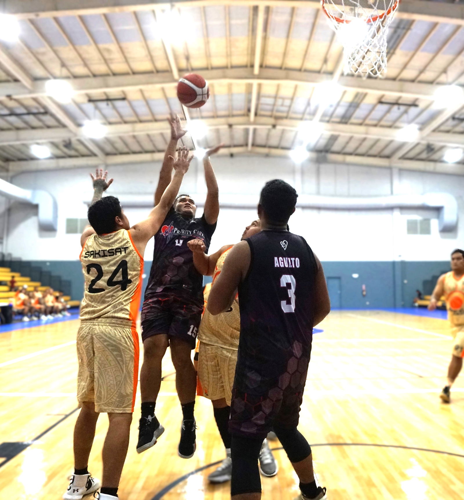 Priority Care’s Bryce Maratita attempts a putback against PSS defenders during the opening game of the 2024 RJ Wine & Liquor Inter-Government/Business Basketball League at the Ada gym on Monday.