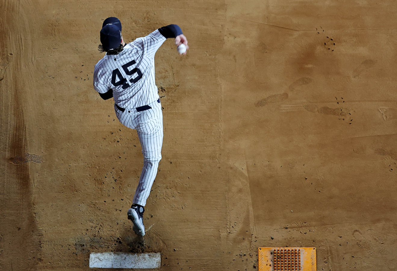New York Yankees pitcher Gerrit Cole (45) warms before playing against the Cleveland Guardians in game two of the ALCS for the 2024 MLB Playoffs at Yankee Stadium in the Bronx, New York, Oct. 15, 2024.