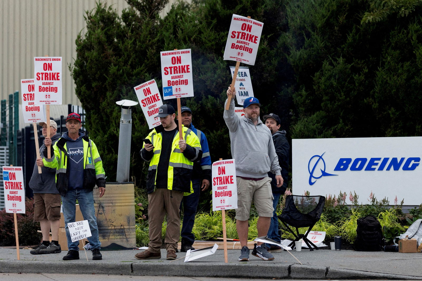 Boeing factory workers gather on a picket line during the first day of a strike near the entrance of a production facility in Renton, Washington, Sept. 13, 2024.