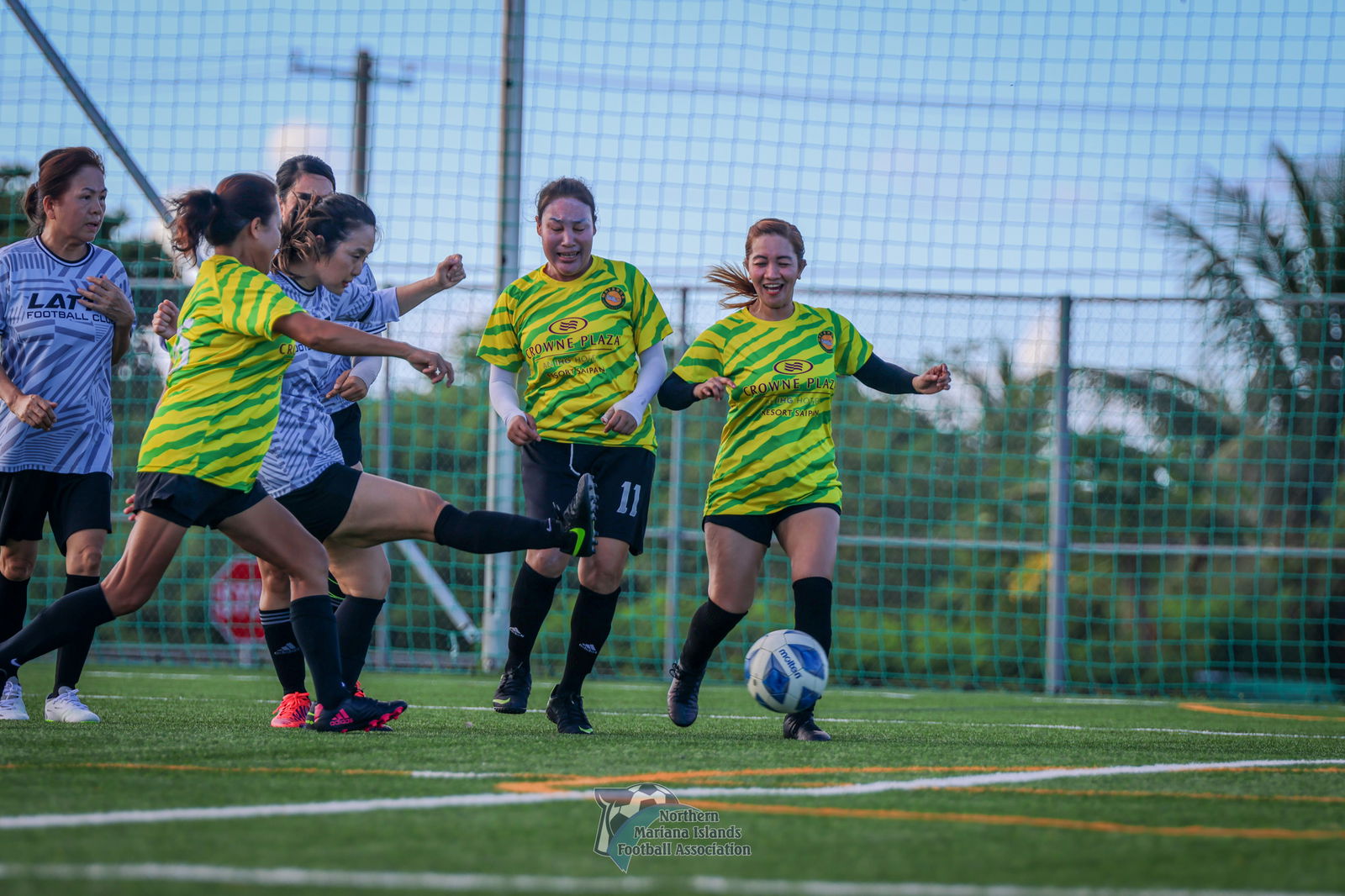 Latte Football Club's Eun Benavente takes a heavily contested shot against Matansa Football Club during a masters division game of the Dove Women's League Fall 2024 at the NMI Soccer Training Center in Koblerville.