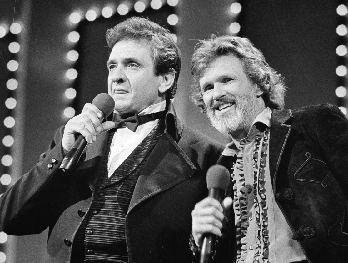 Country stars Johnny Cash, left, and Kris Kristofferson sing during the Country Music Awards in Nashville, Tenn., Oct. 1983.