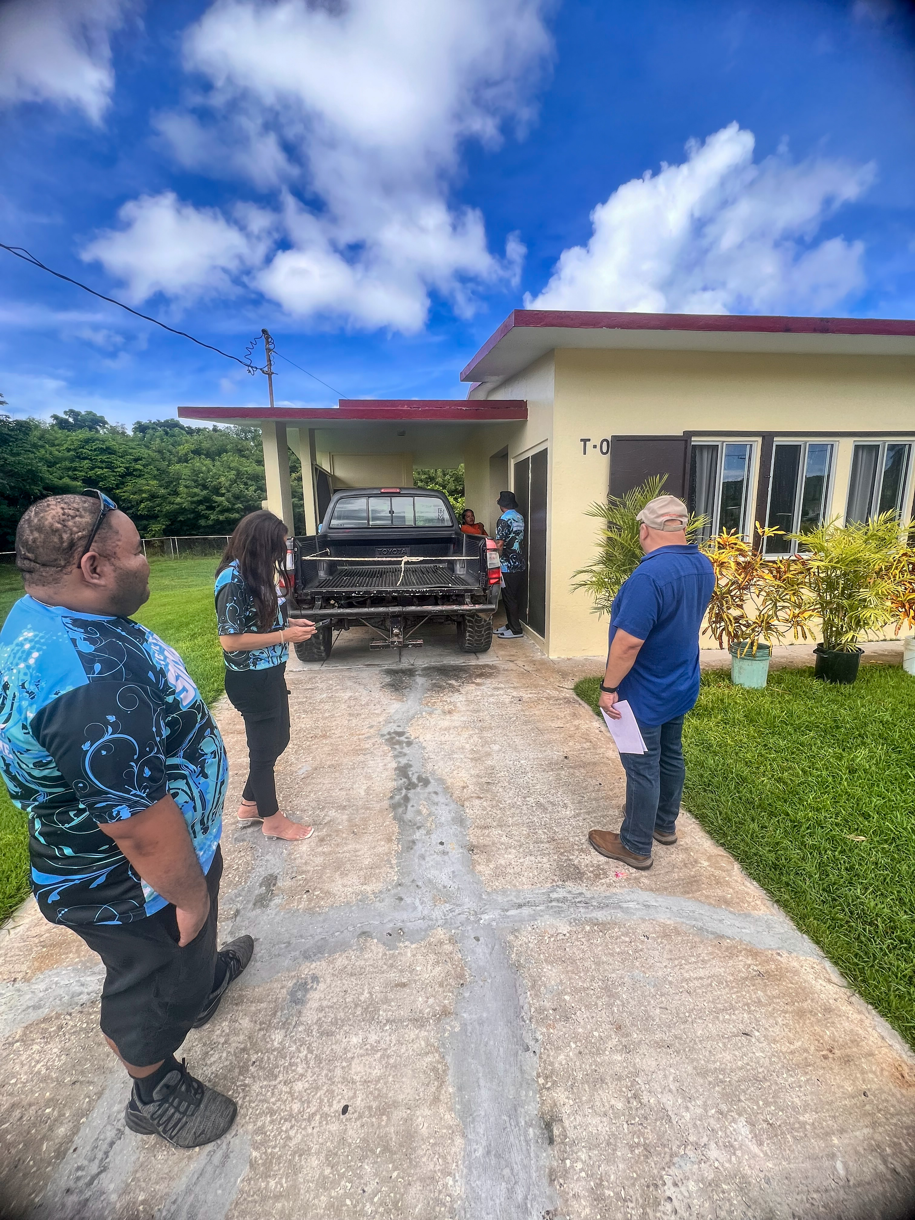 During their house-to-house visits on Tinian, Early Intervention Program Director Robin Palacios shows Commissioner of Education Dr. Lawrence F. Camacho how her team members Nace Soalabai and Peter Mendiola reinforce their awareness campaign to ensure that families avail themselves of the free services provided by the PSS EI Program.