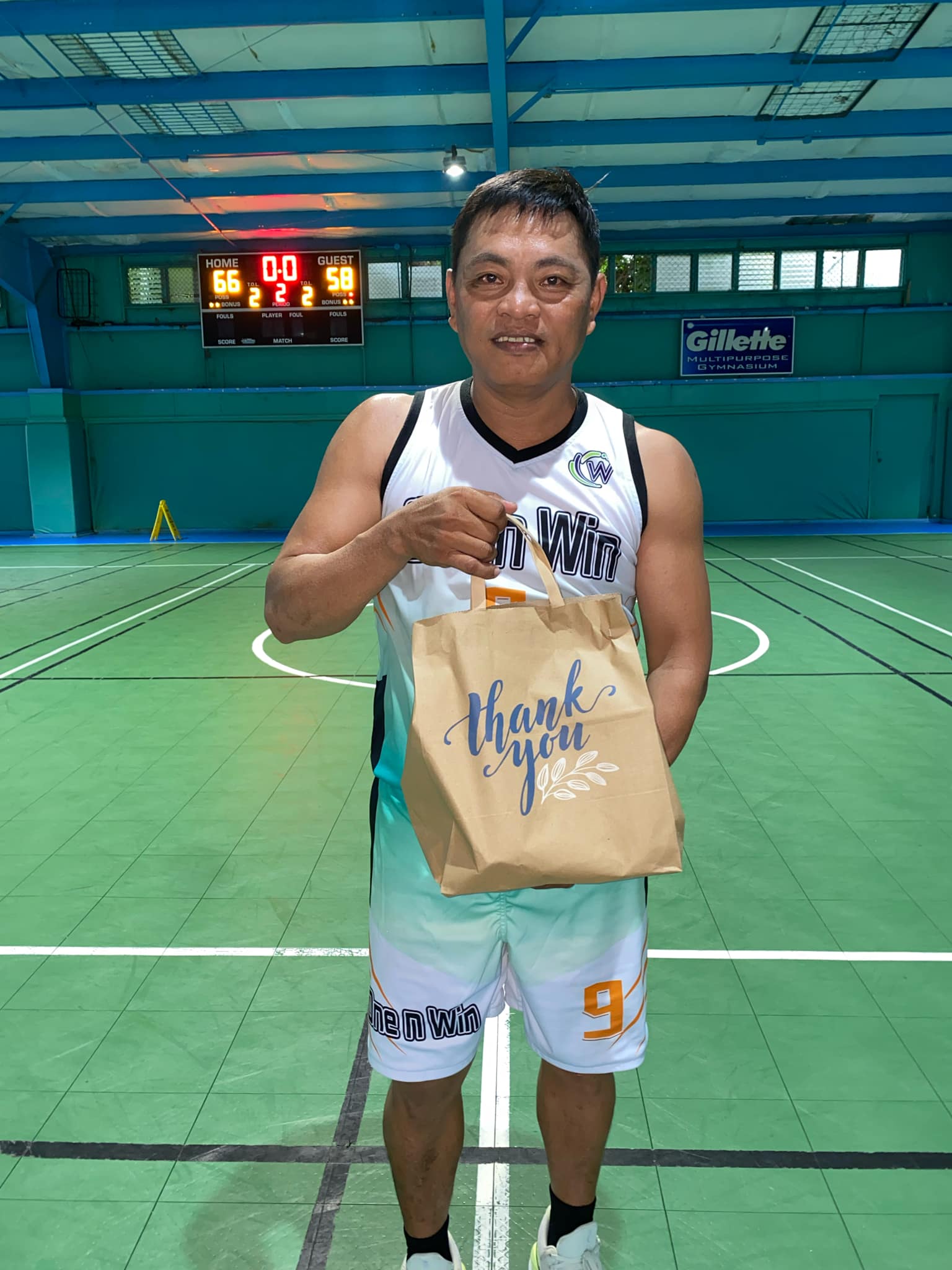 One n Win’s Vinz Rodriguez poses with his prize as Player of the Game after their victory against El Champions in the Win Pacific Corporation Invitational Basketball League 2024 at the TSL Sports Complex on Sunday.