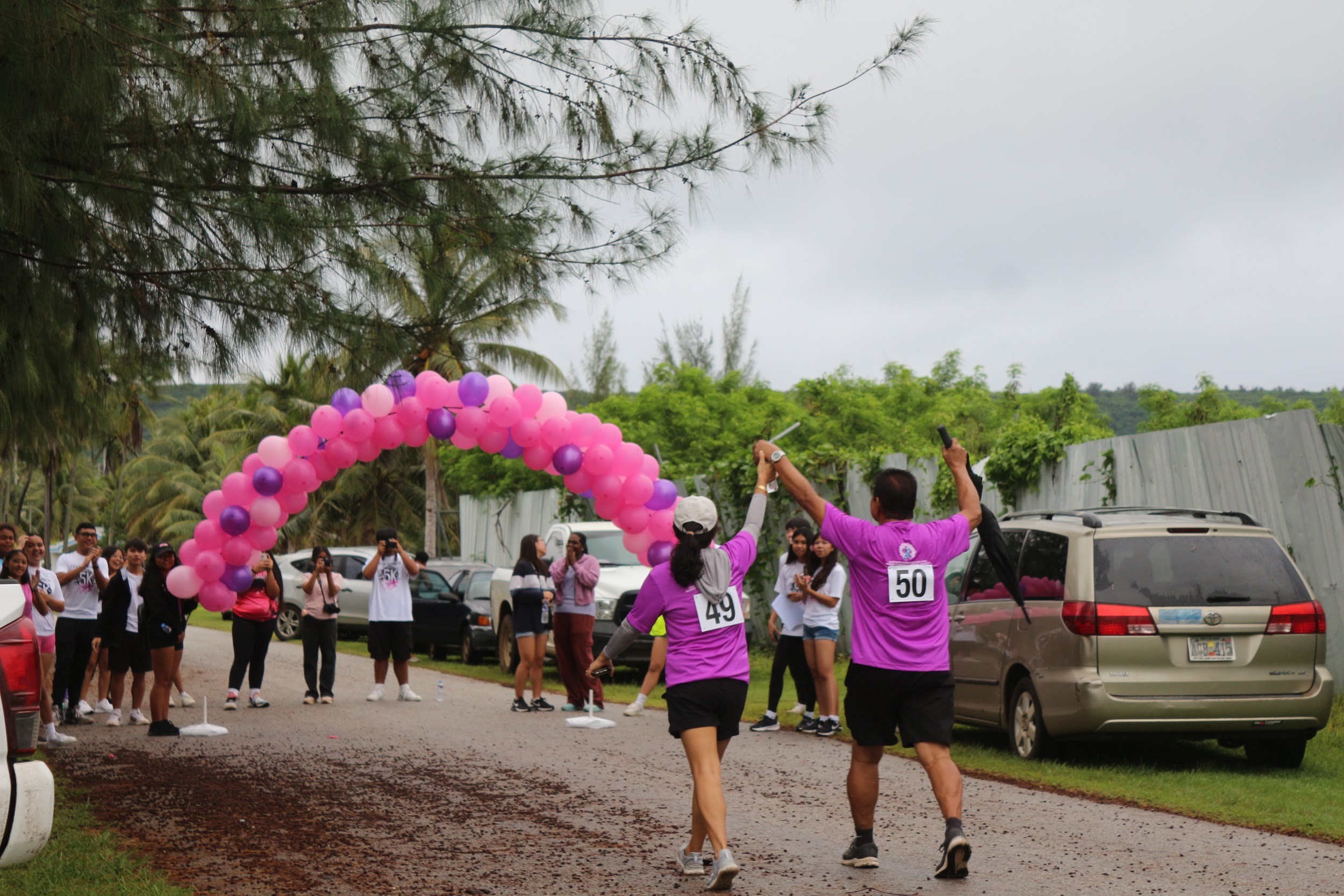 Mr. & Mrs. Bill Cing finish the race with the JROTC cadets cheering on their victory.