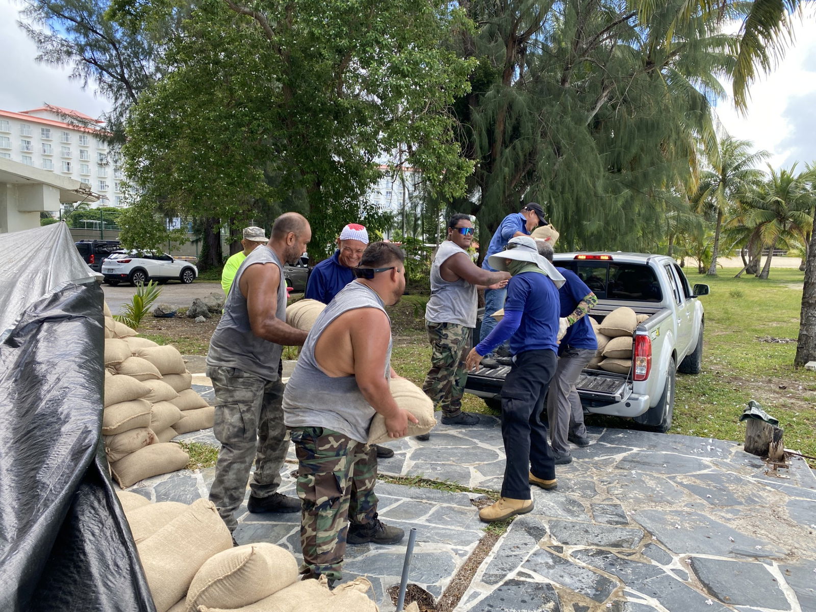 With the bags they filled with sand, Department of Public Lands staff members will cover the World War II debris at the beach near the former Hyatt.
