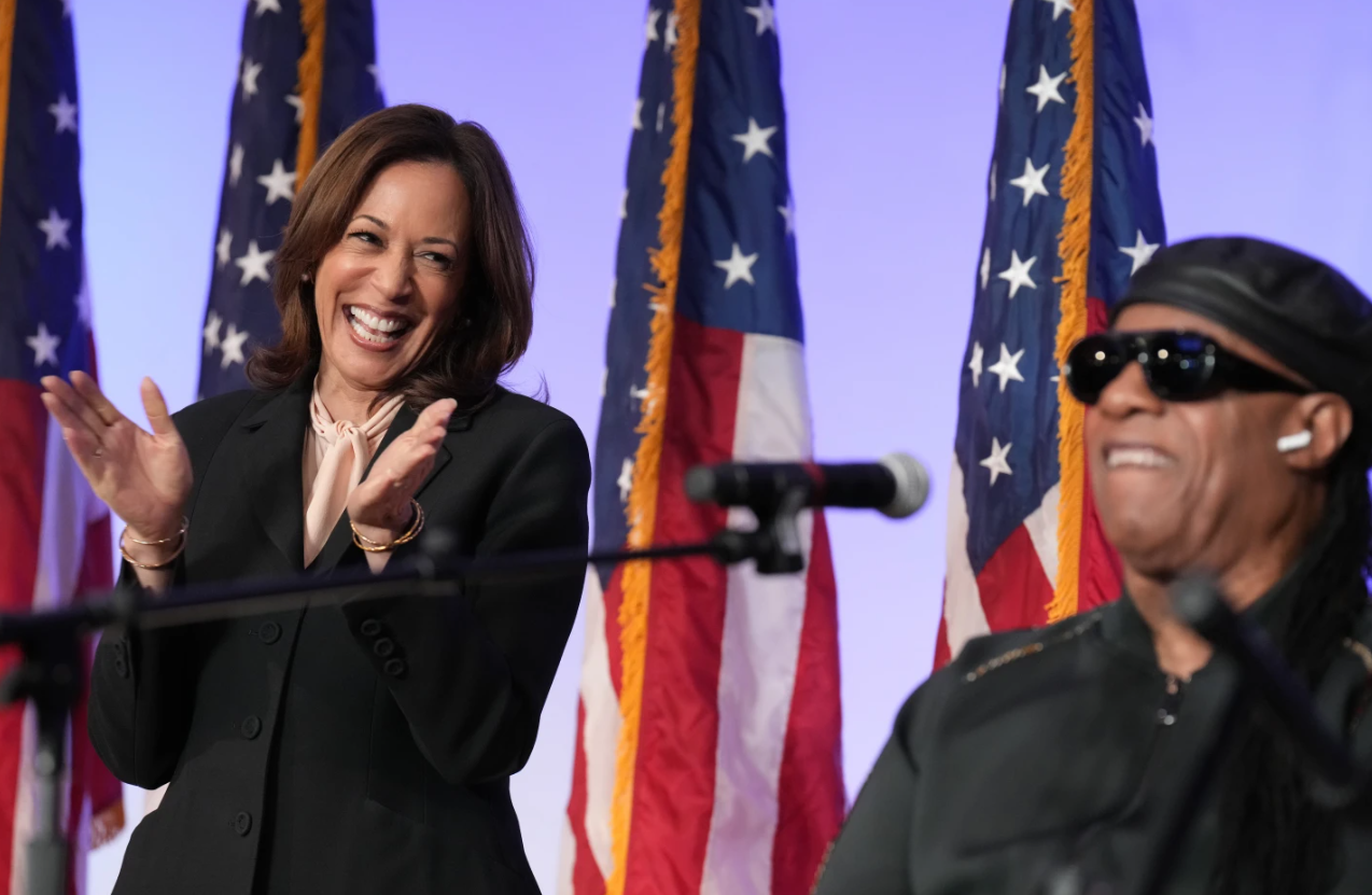 Democratic presidential candidate Kamala Harris listens as Stevie Wonder performs “Redemption Song” during a church service and early vote event at Divine Faith Ministries International, Sunday, Oct. 20, 2024 in Jonesboro, Ga.