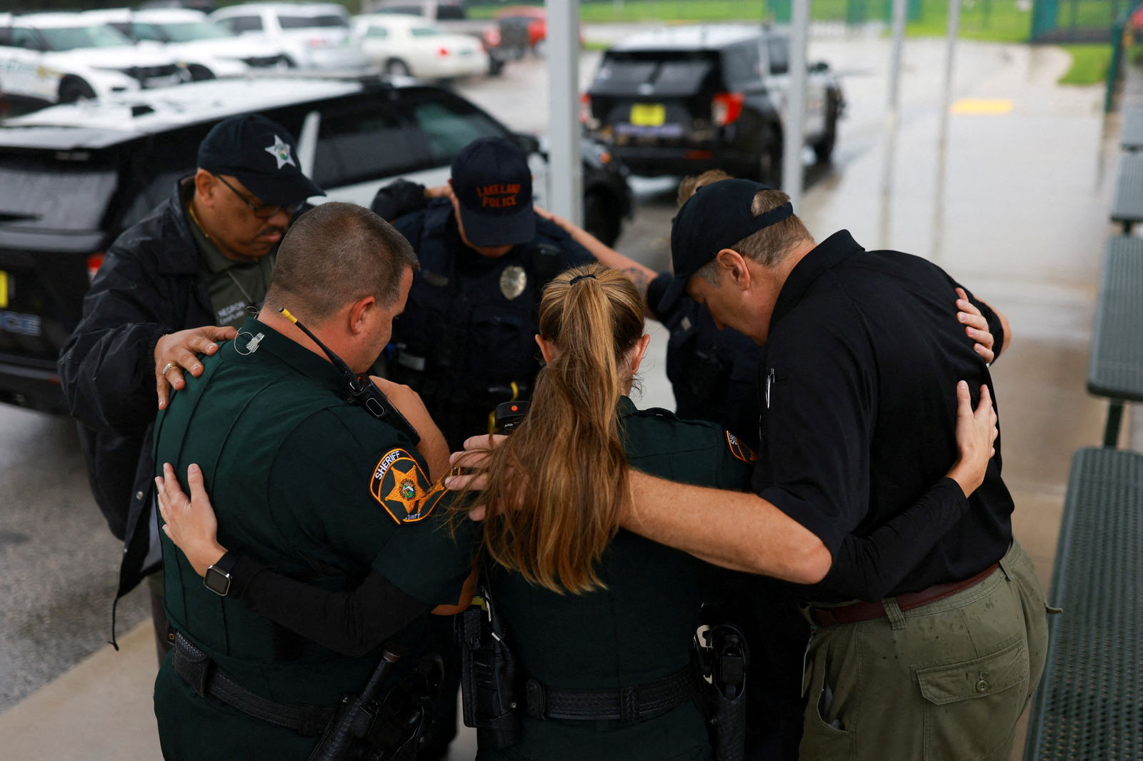 Members of the Polk County Sheriff's Office pray outside a shelter as Hurricane Milton approaches, in Lakeland, Florida, Oct. 9, 2024.