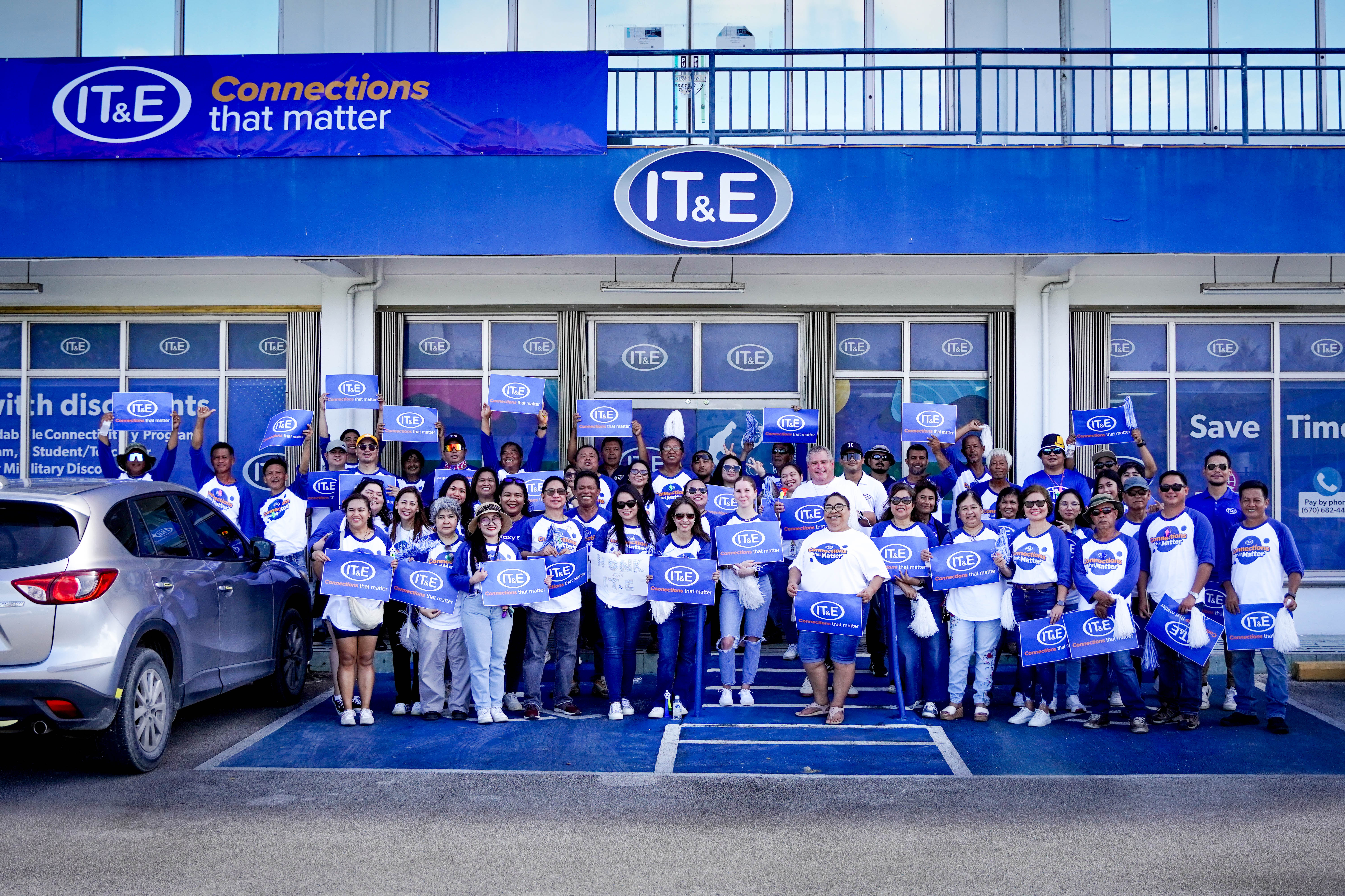IT&E employees pose in front of their offices during a recent brand launch.