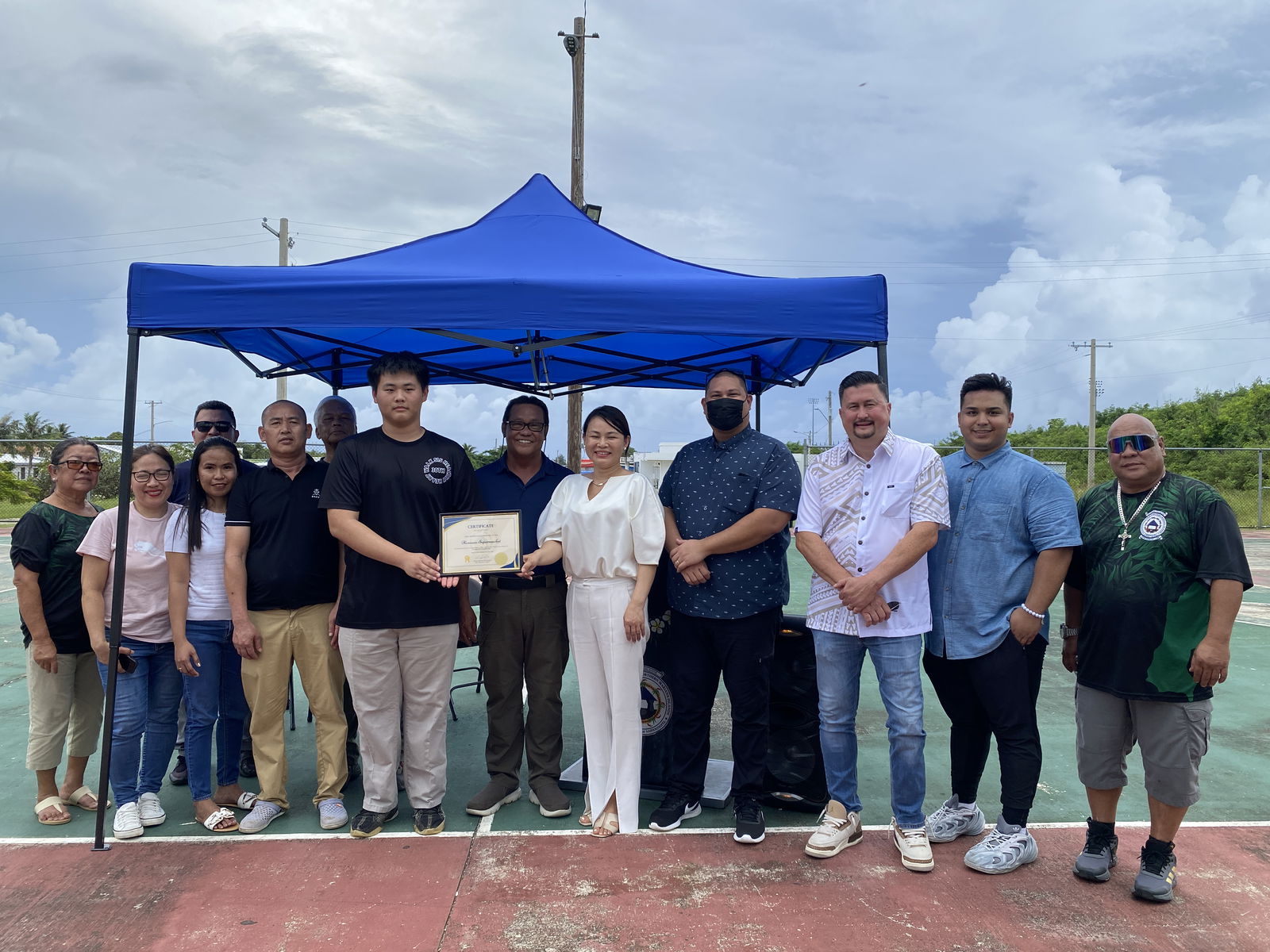 Charlie Lee, holding a certificate, spearheaded a collaboration that brought together Han Nam Supermarket and the Mayor’s Office of Saipan. Also in photo are Mayor RB Camacho, center, Rep. Diego Camacho, 4th right, and House Floor Leader Ed Propst, 3rd right.