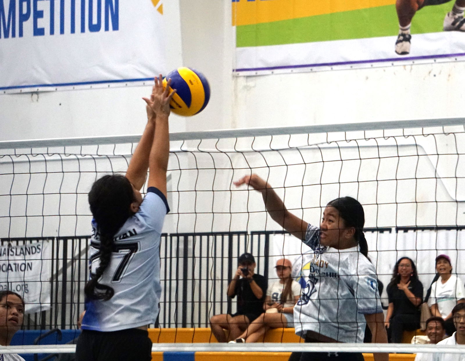 GCA’s Eunice Pagaduan blocks the spike attempt of MHS' Erica Zandueta in the girls high school division title match of the PSS-NMIVA Interscholastic Volleyball League SY24-25 at the MHS gym on Tuesday. 