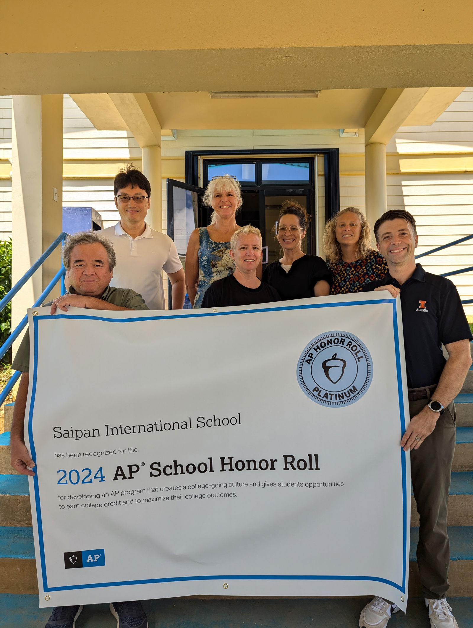 Saipan International School’s AP teachers hold an AP Honor Roll banner.