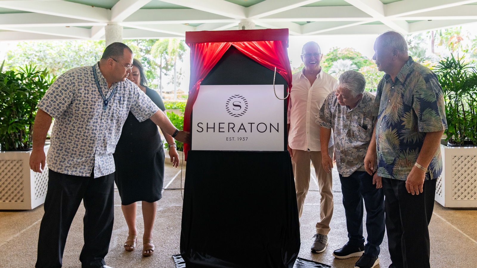 From left, House Speaker Edmund Villagomez, Senate President Edith Deleon Guerrero, MB Capital LLC President David Hood, Gov. Arnold I. Palacios and Lt. Gov. David M. Apatang unveil the Sheraton brand name in the lobby of the former Hyatt Regency Saipan on Tuesday.