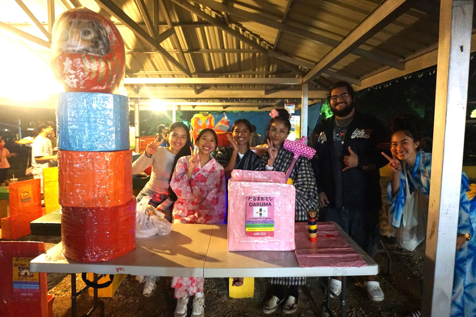 Members of the Kagman High School’s Japanese Culture Club pose for a photo at their game booth.
