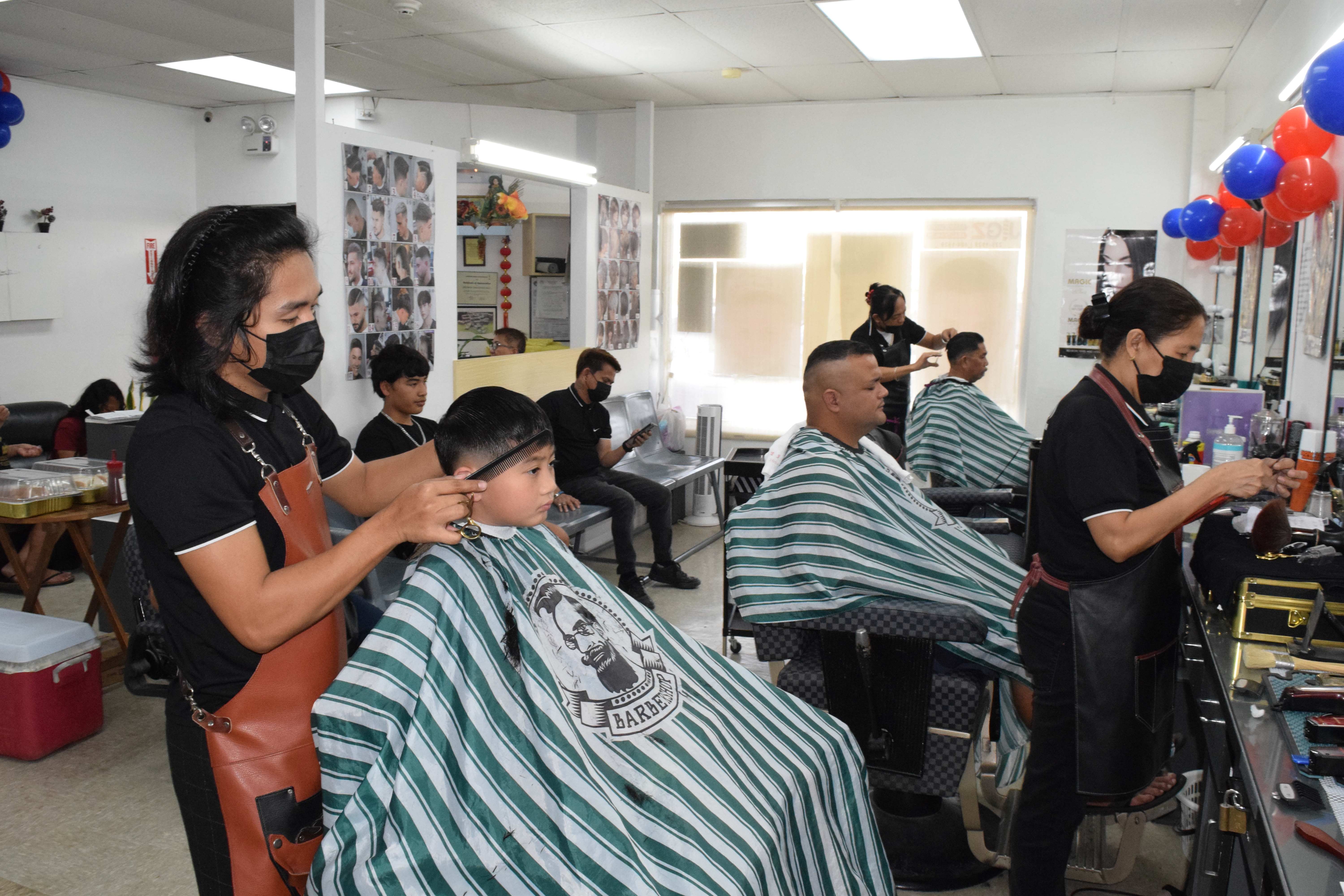 Jigz Barber Shop & Beauty Salon hairstylists attend to customers on Saturday.