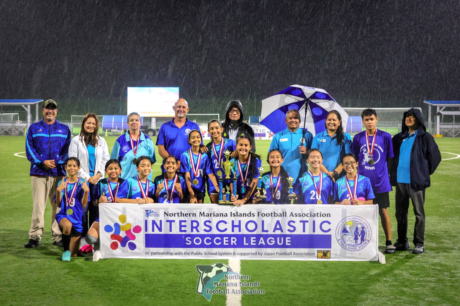 Saipan International School players pose for a photo with NMIFA and PSS officials after winning the girls middle school division title of the PSS-NMIFA Interscholastic Soccer League SY24-25 at the NMI Soccer Training Center on Tuesday. 