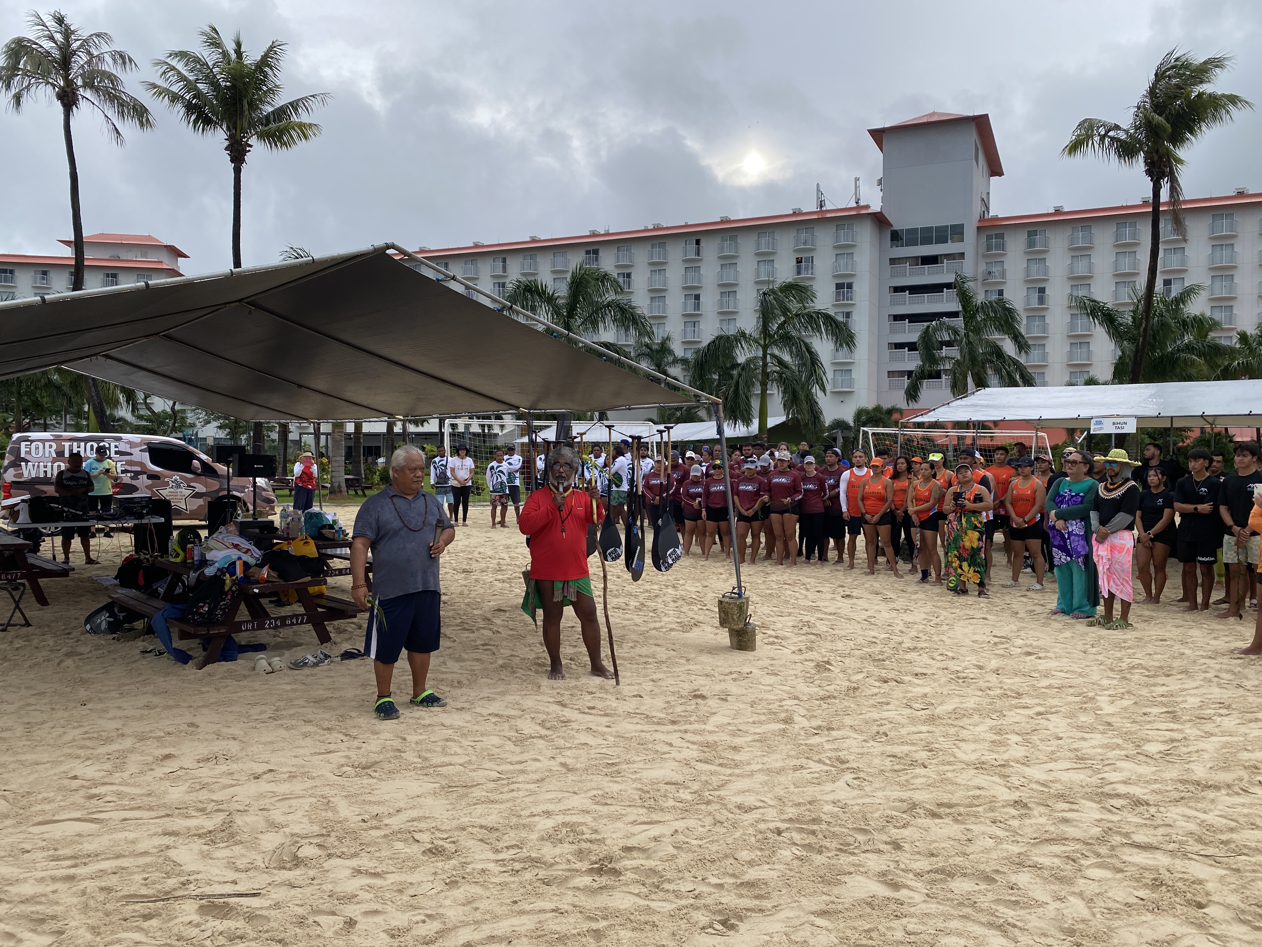 Donald Mendiola, left, and Mario Benito bless the canoes and racers on the second day of Micro Cup.
