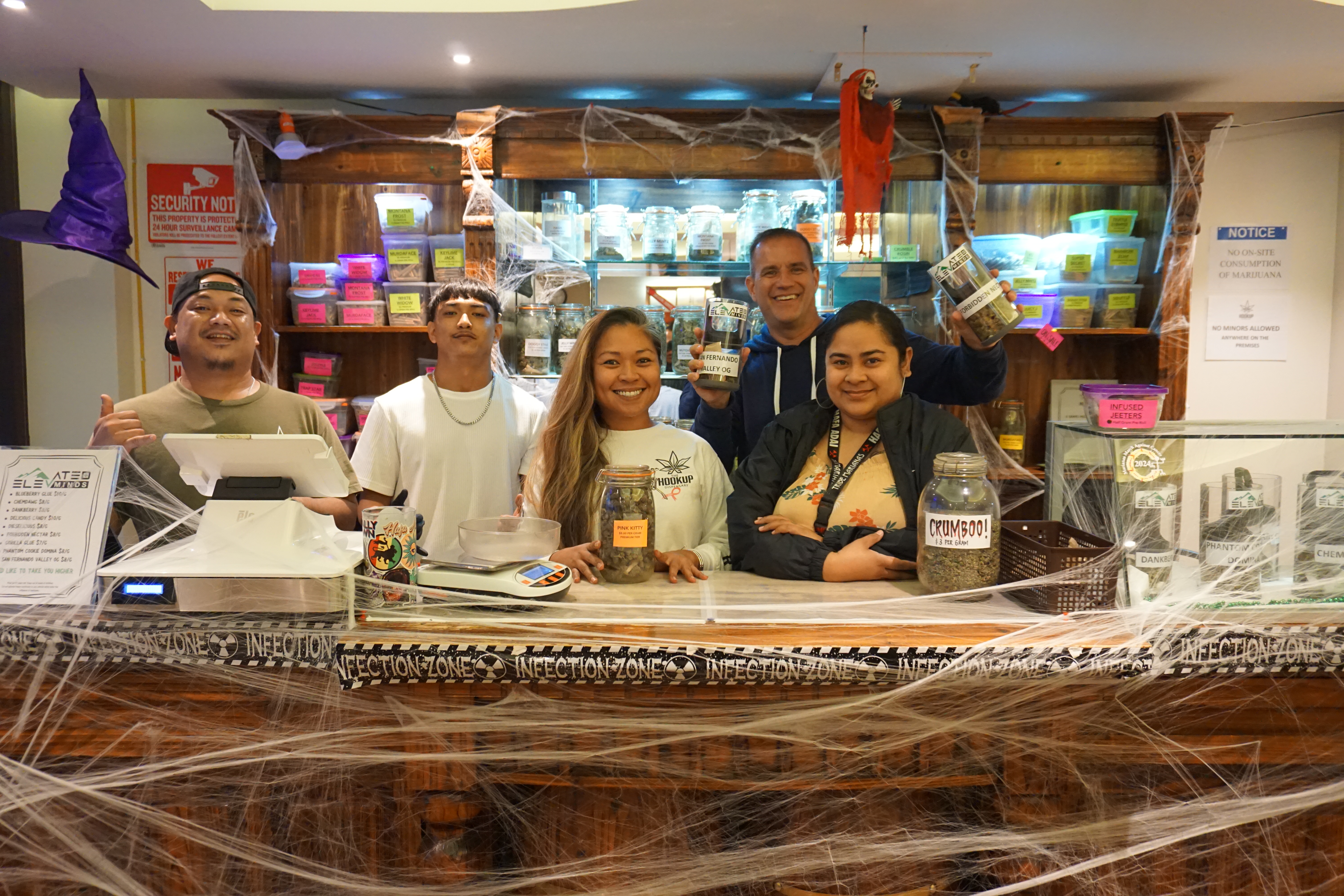 Jen Sambile, center, and Scot Malin, back row, pose with The Hookup staff.