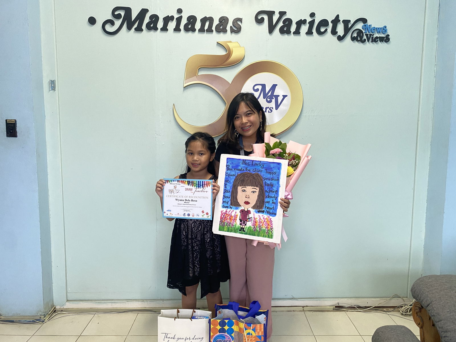 Wyuna Dela Rosa left, and her teacher, Lovely Cruz from WSR Elementary School. 