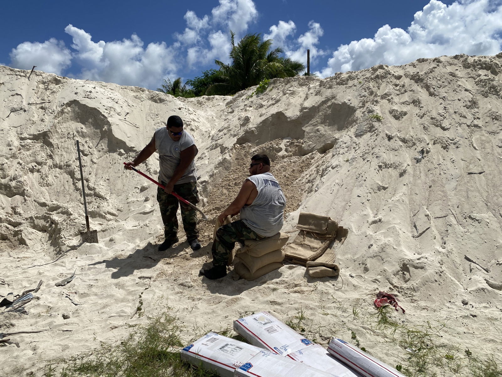 Department of Public Lands staff members fill sand bags on Wednesday, Oct. 2.